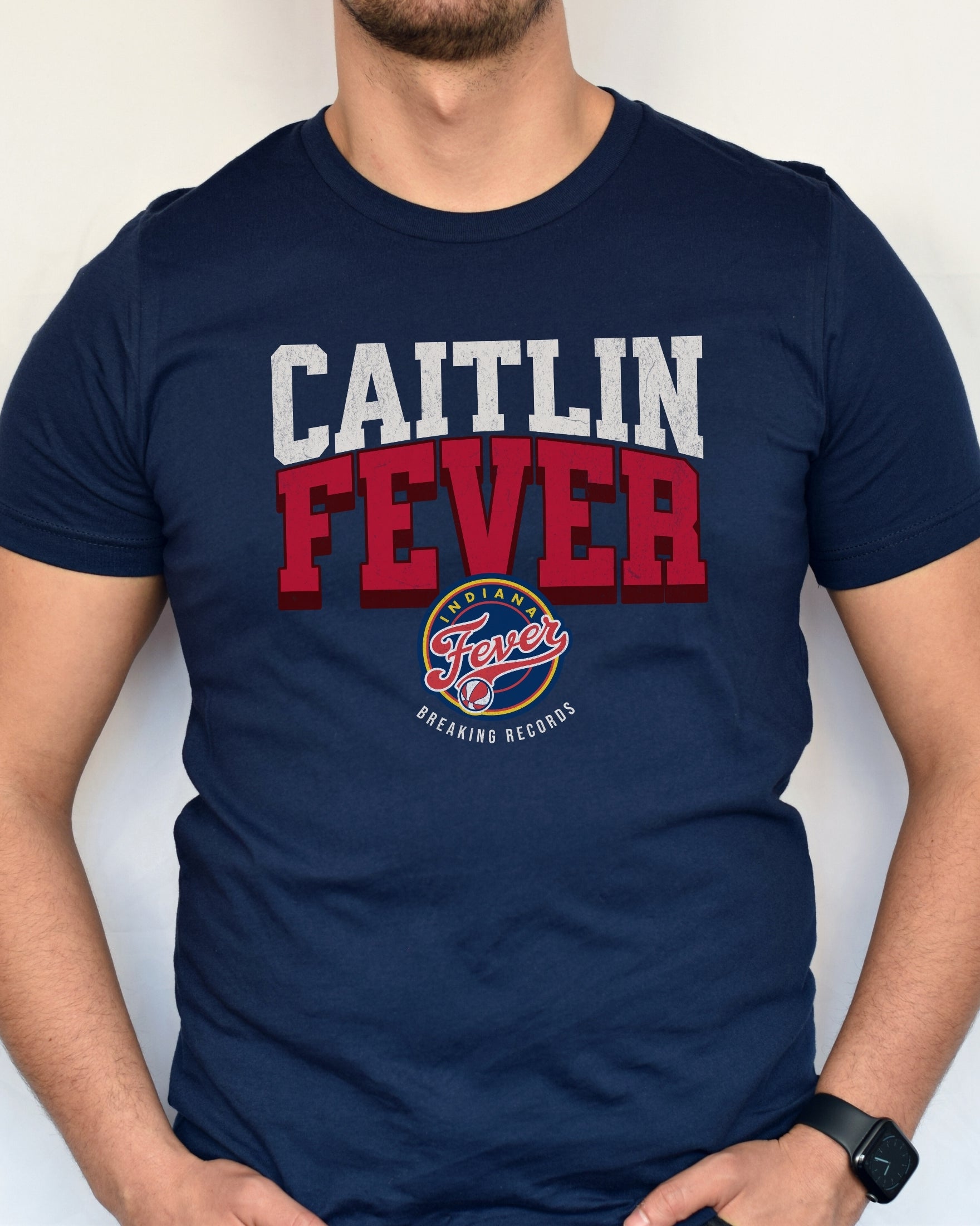 Man wearing navy Caitlin Fever shirt