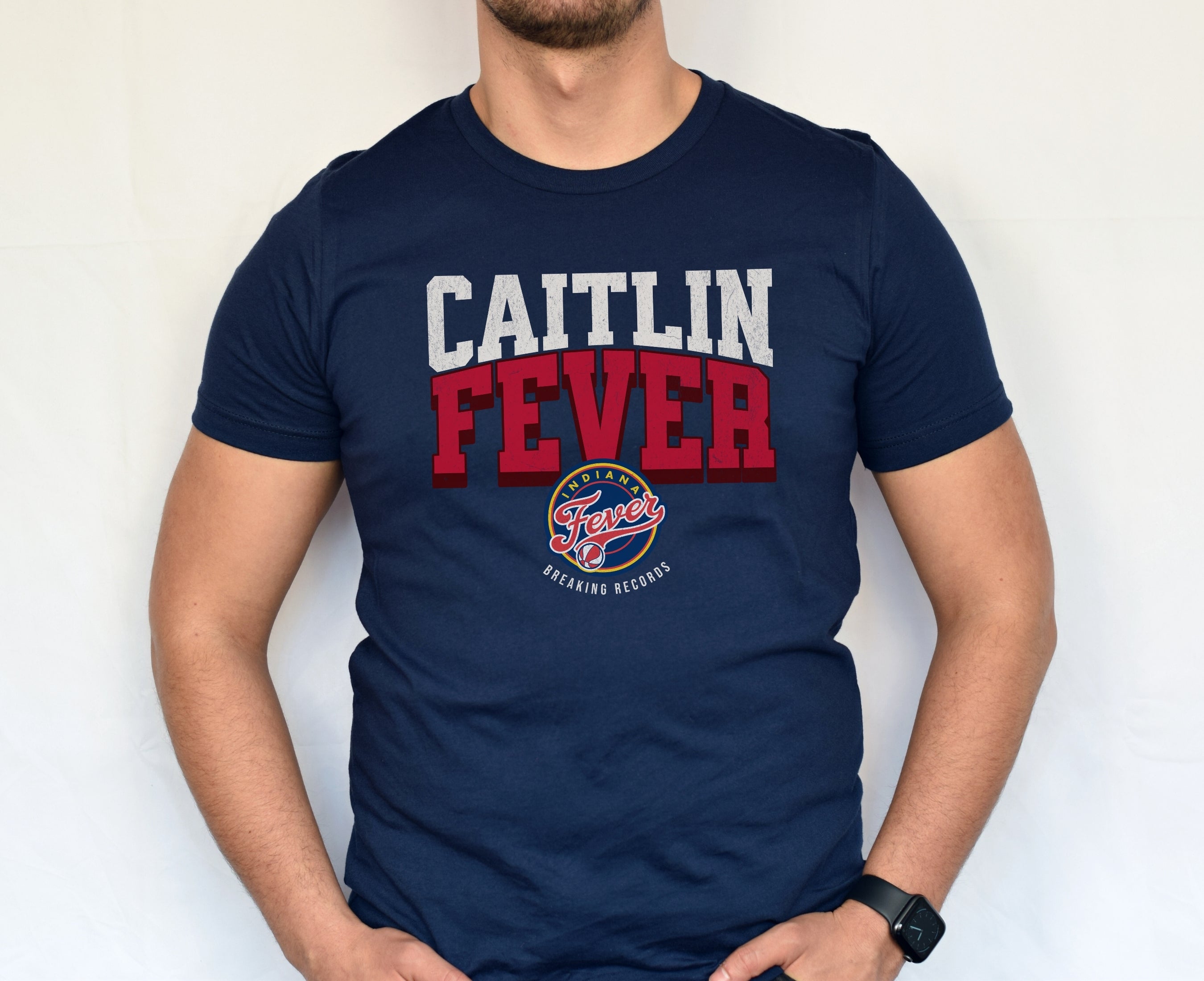 Man wearing navy Caitlin Fever shirt