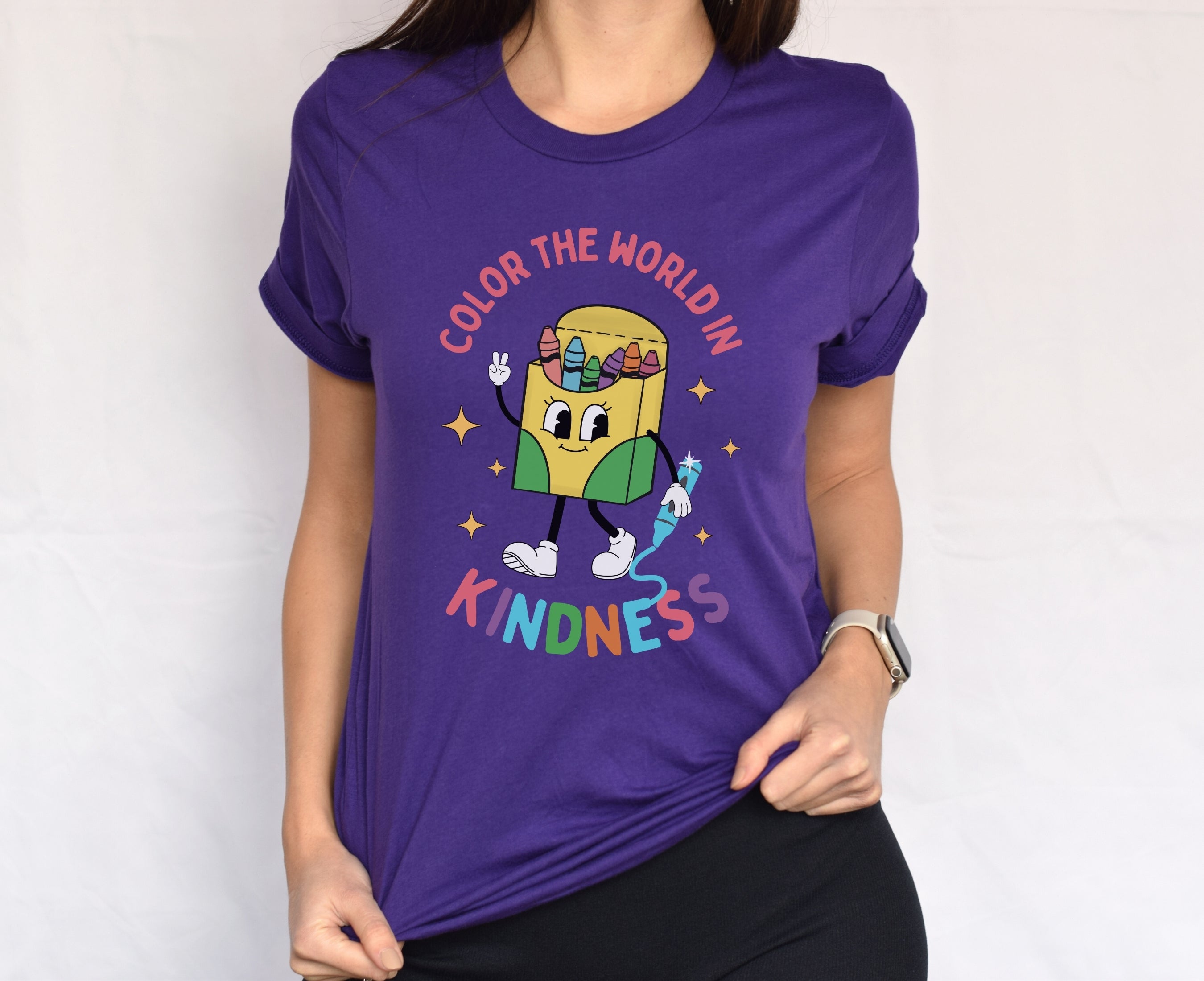 Teacher wearing team purple color the world in kindness shirt
