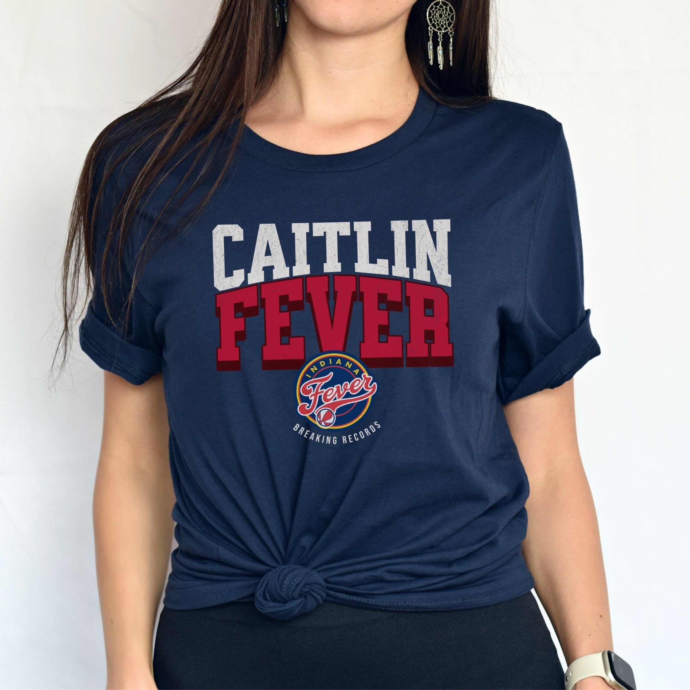 Woman wearing navy Caitlin Fever shirt