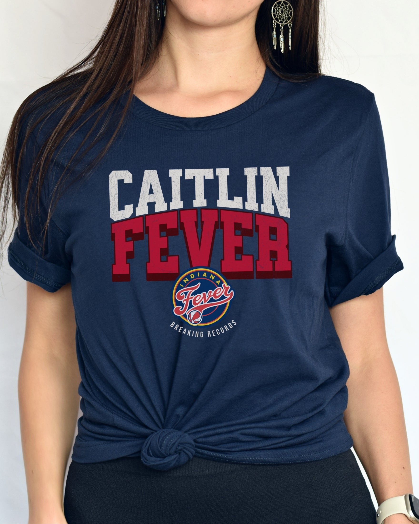 Woman wearing navy Caitlin Fever shirt