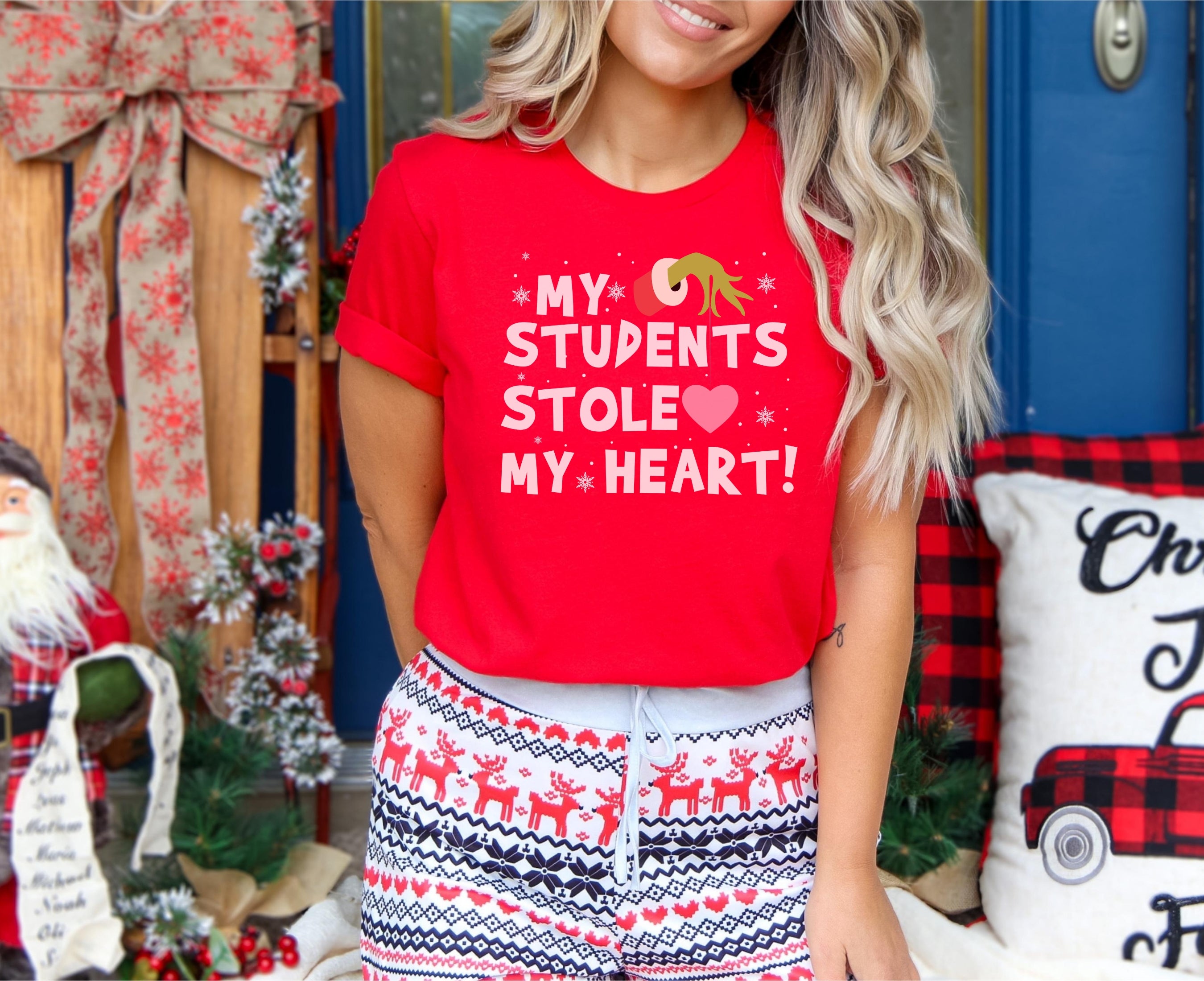 Young teacher wearing my students stole my heart t-shirt in red