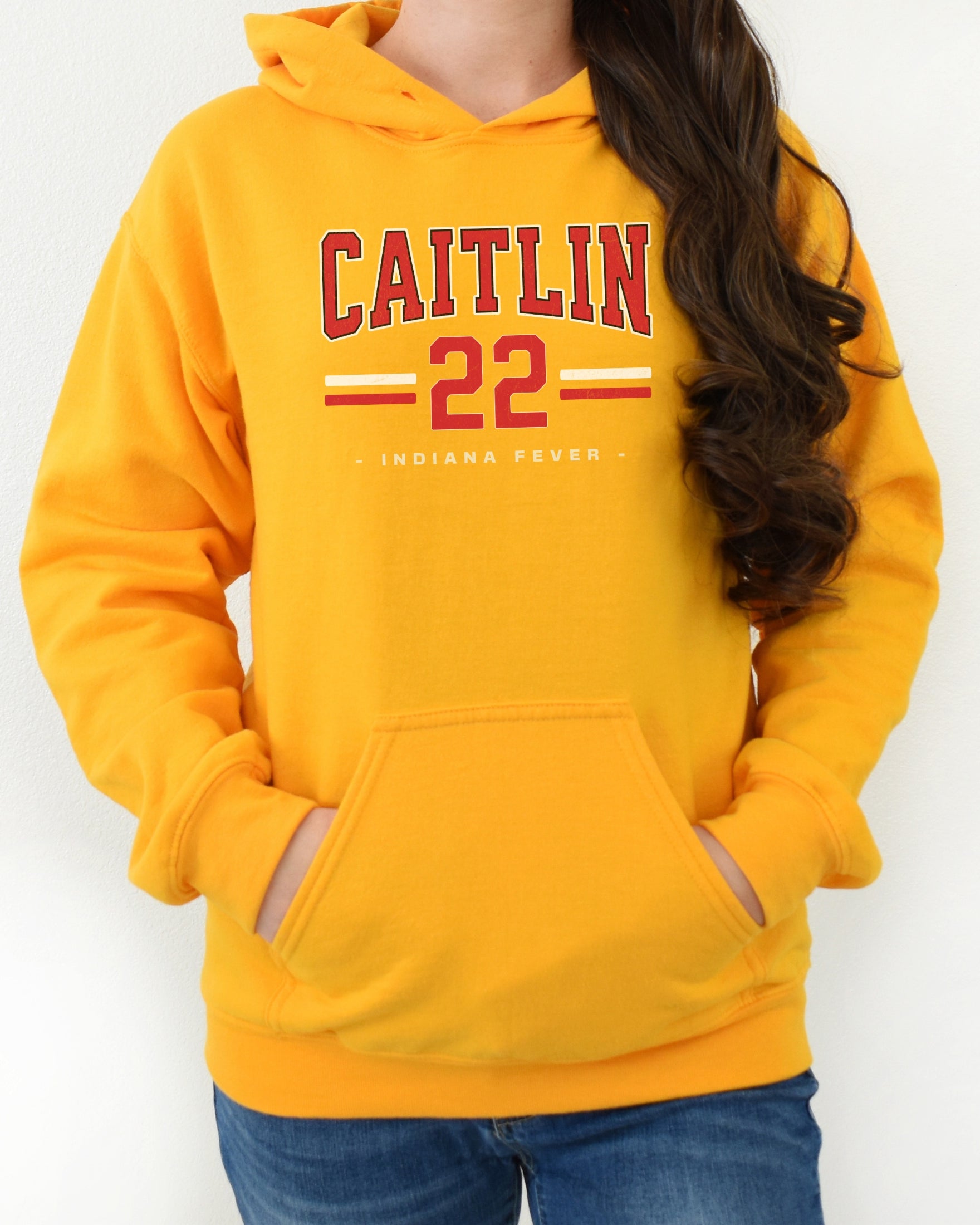 Girl wearing gold Caitlin Clark 22 Hoodie