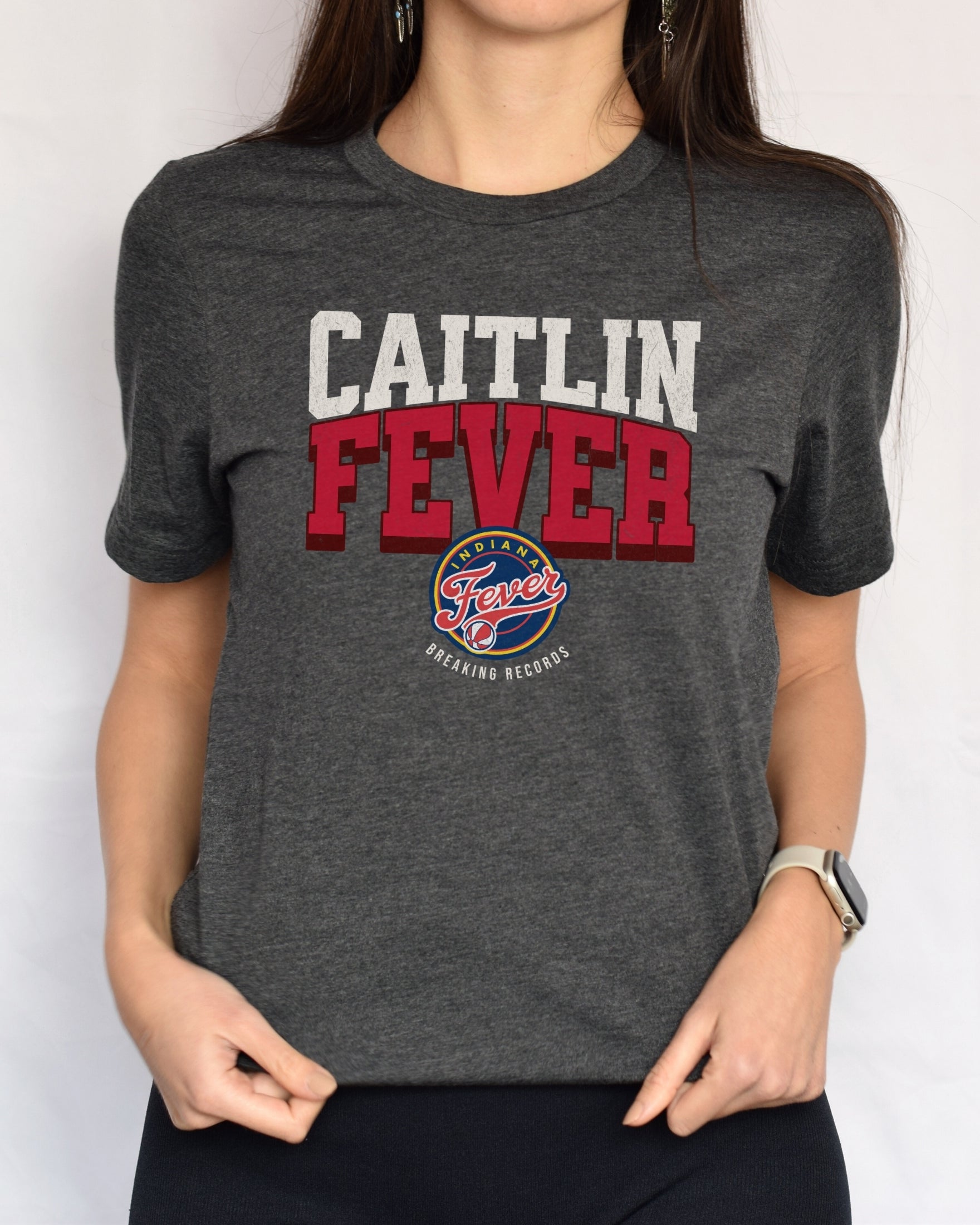 Woman wearing dark grey heather Caitlin Fever shirt