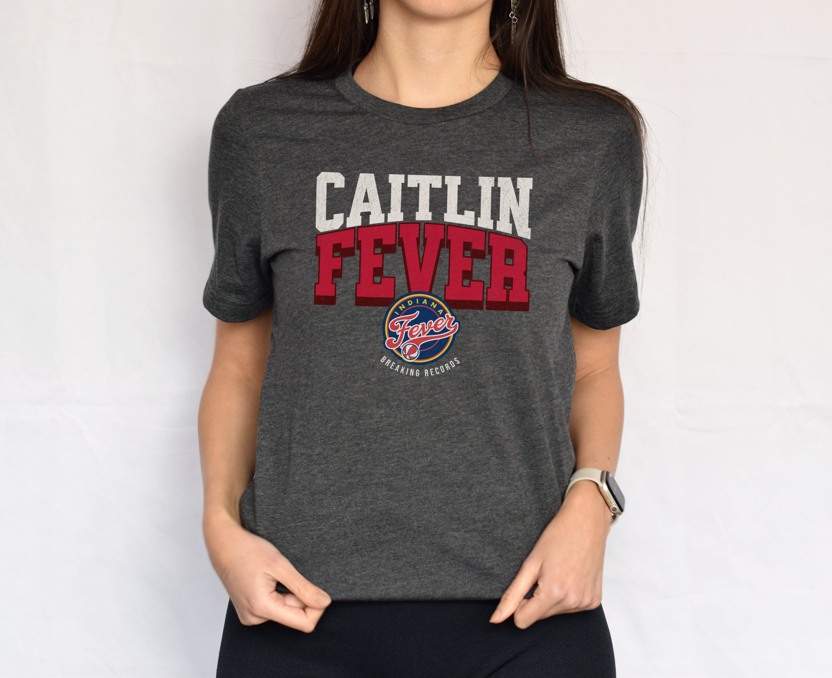 Woman wearing dark grey heather Caitlin Fever shirt