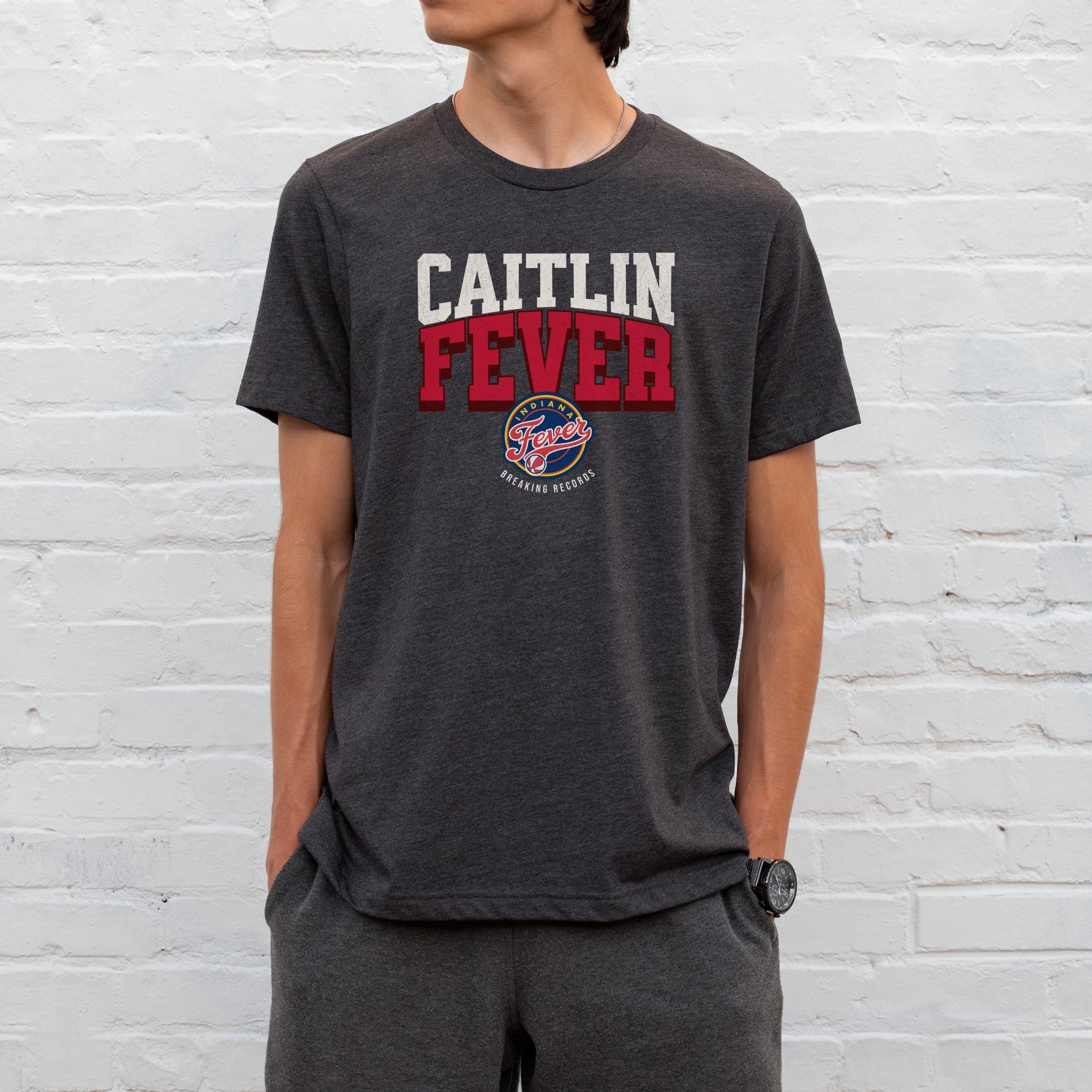 Man wearing dark grey heather Caitlin Fever shirt