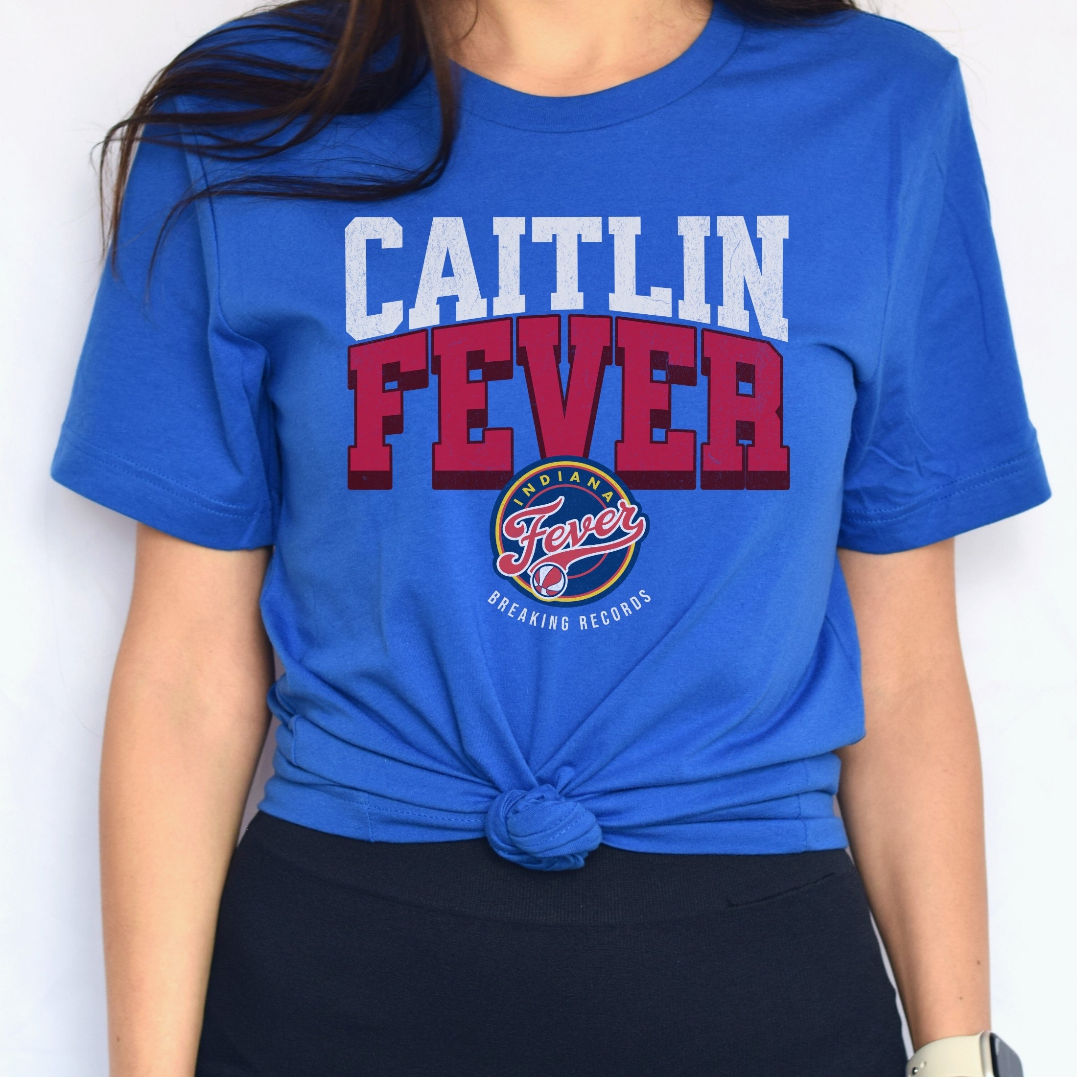 Woman wearing true royal blue Caitlin Clark Fever t-shirt