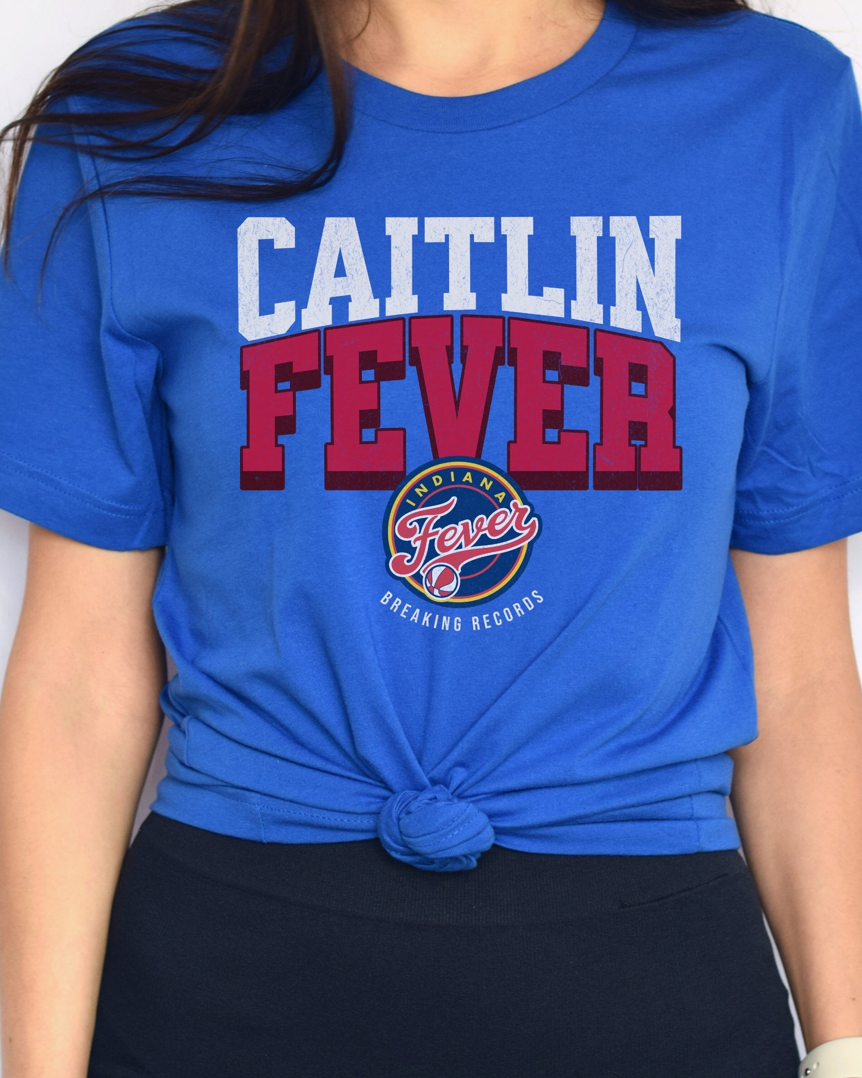 Woman wearing true royal blue Caitlin Clark Fever t-shirt