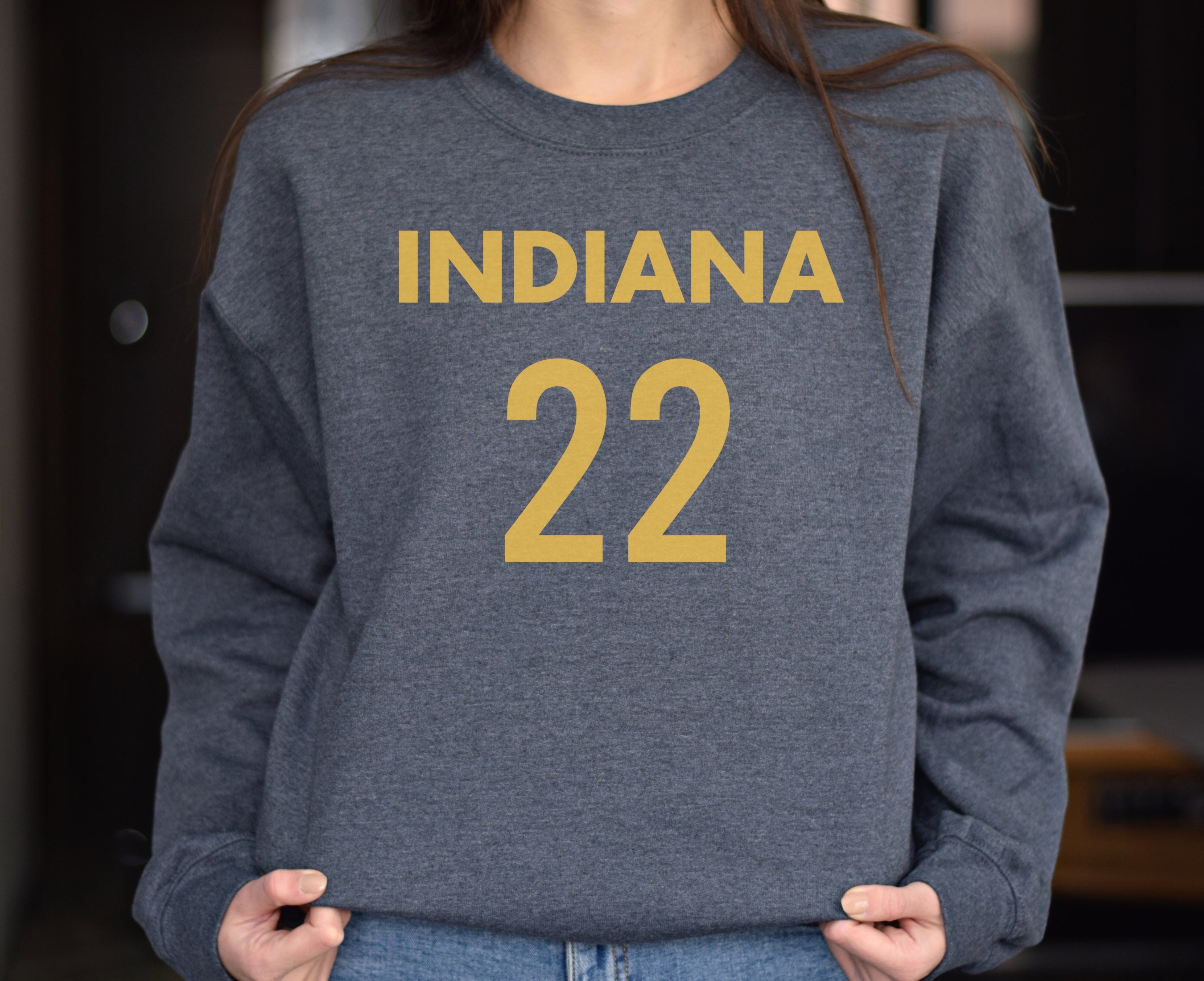 Girl wearing dark heather Indiana 22 Caitlin Clark sweatshirt