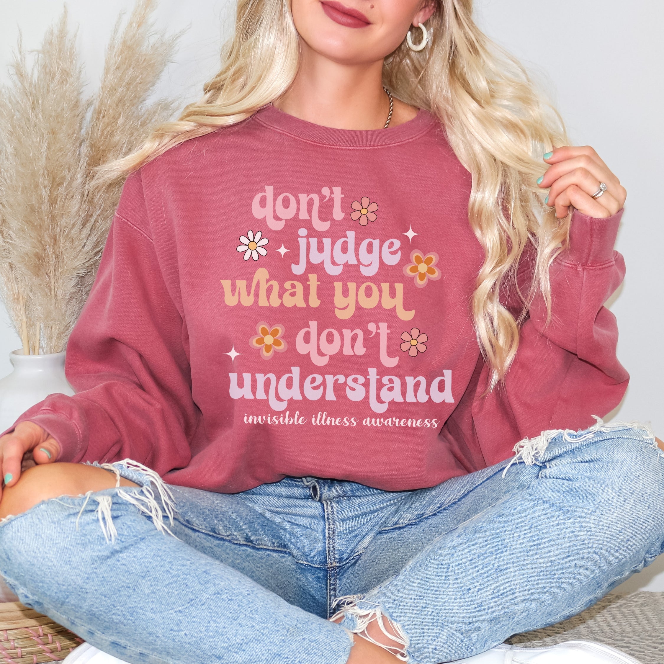 Girl wearing invisible illness Comfort Colors sweatshirt in crimson
