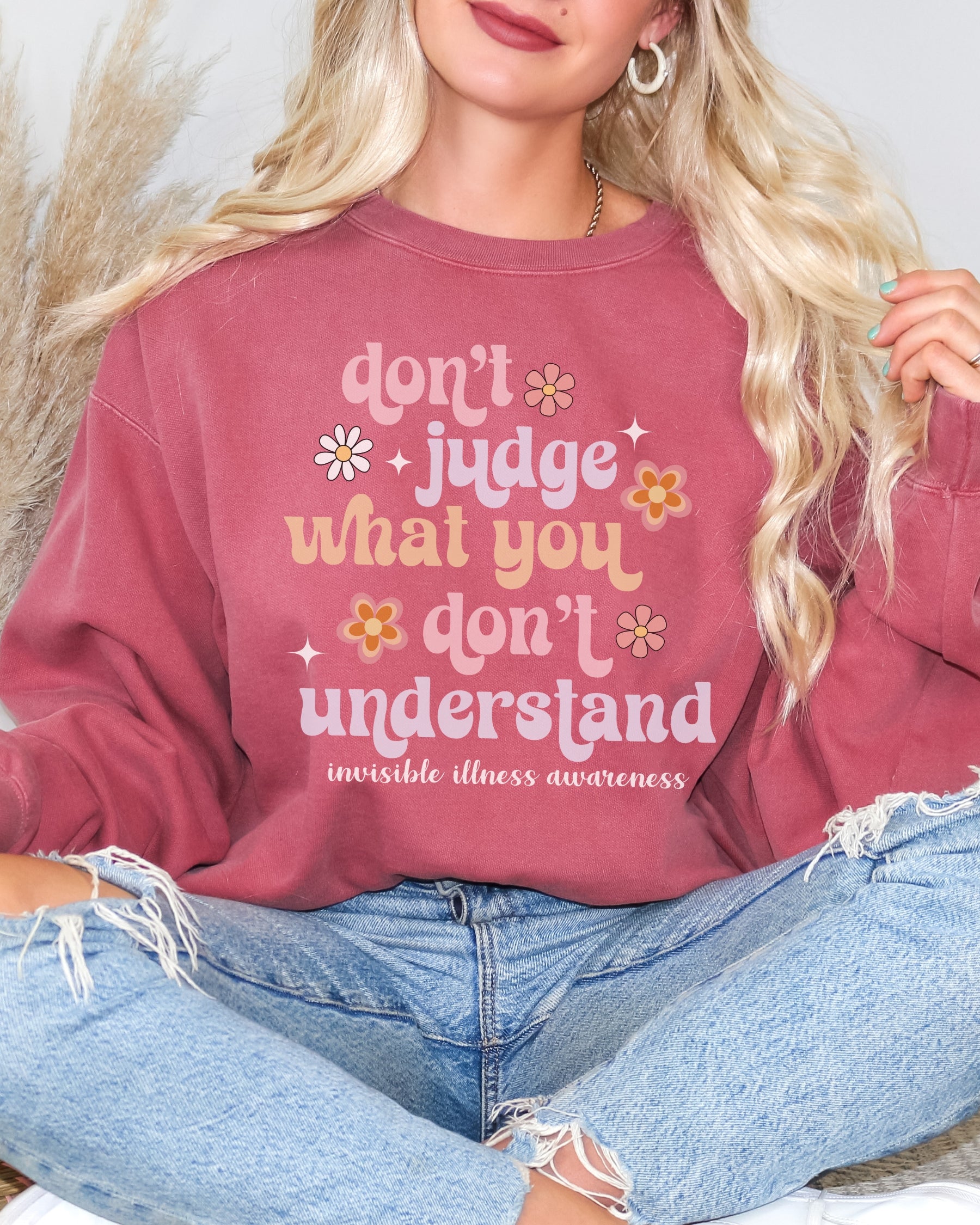 Girl wearing invisible illness Comfort Colors sweatshirt in crimson