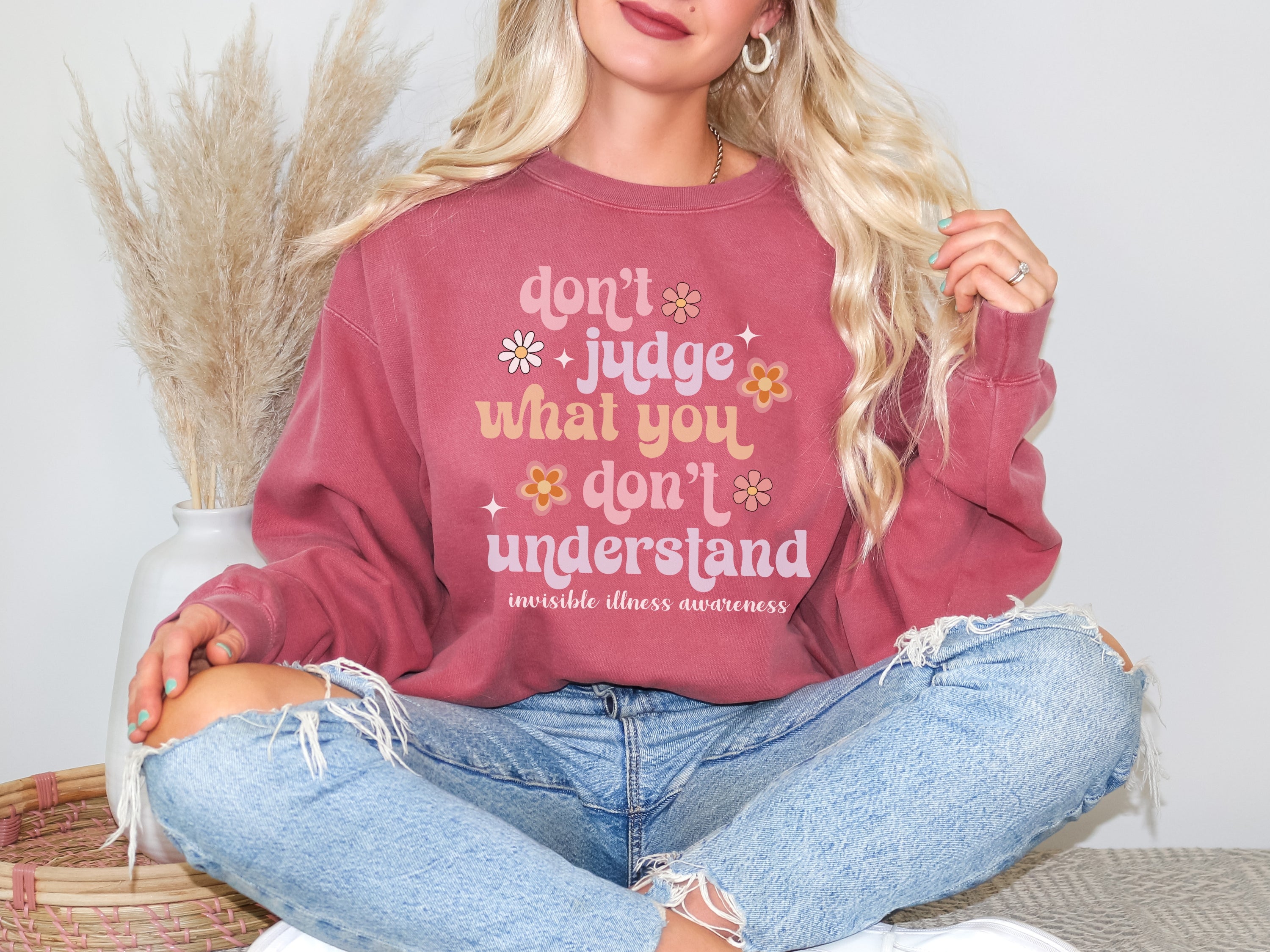 Girl wearing invisible illness Comfort Colors sweatshirt in crimson