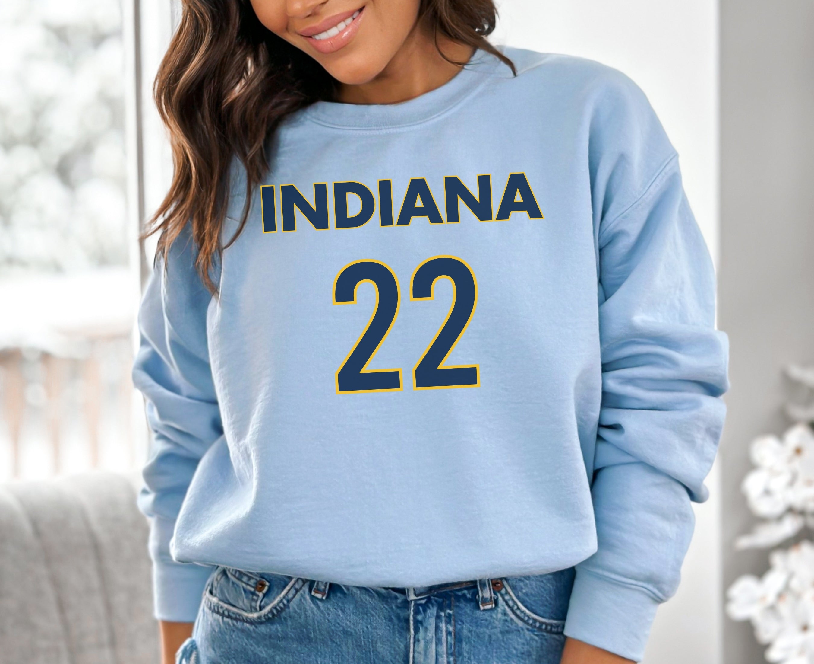 Girl wearing light blue Indiana 22 sweatshirt