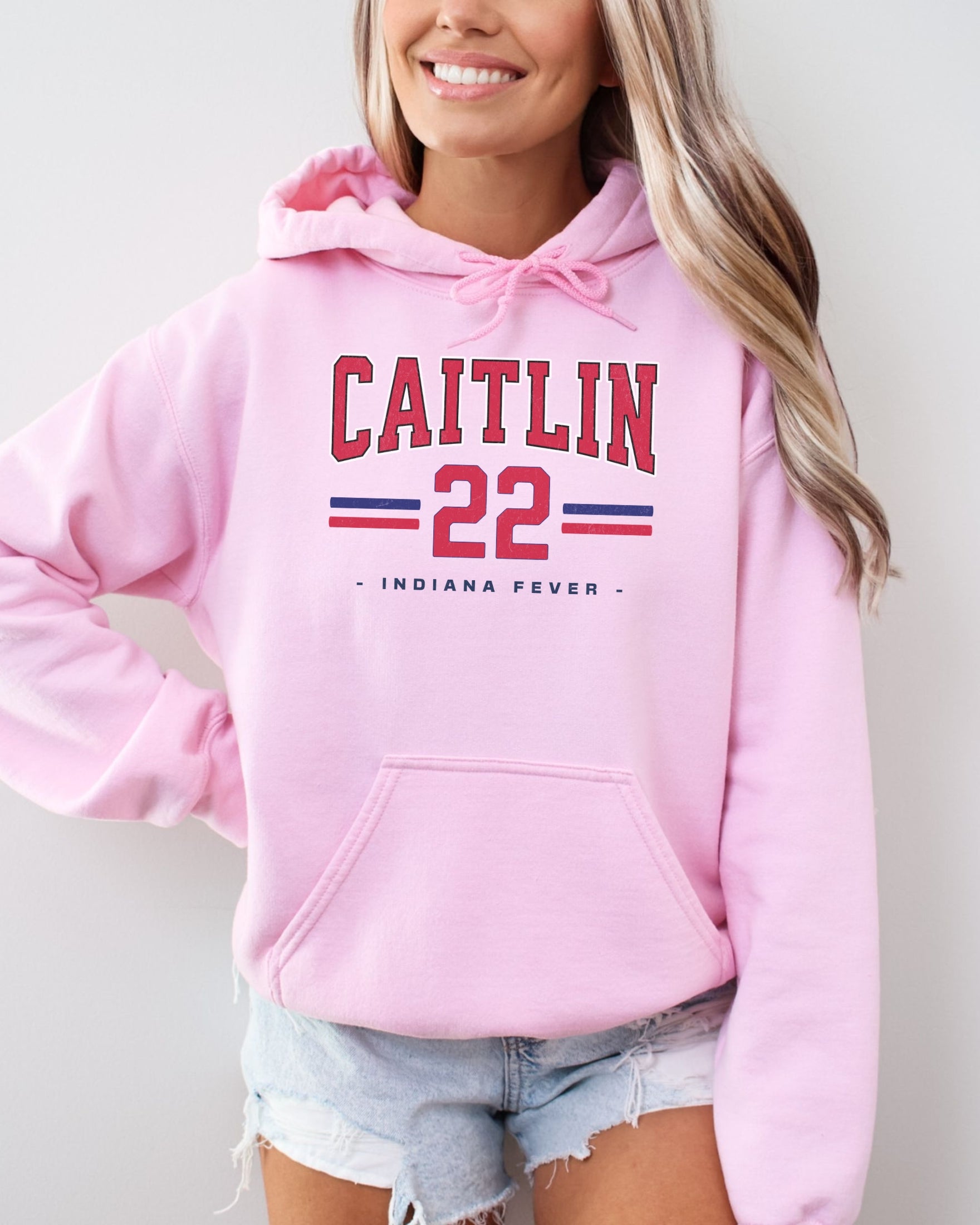 Girl wearing light pink Caitlin Clark 22 Hoodie