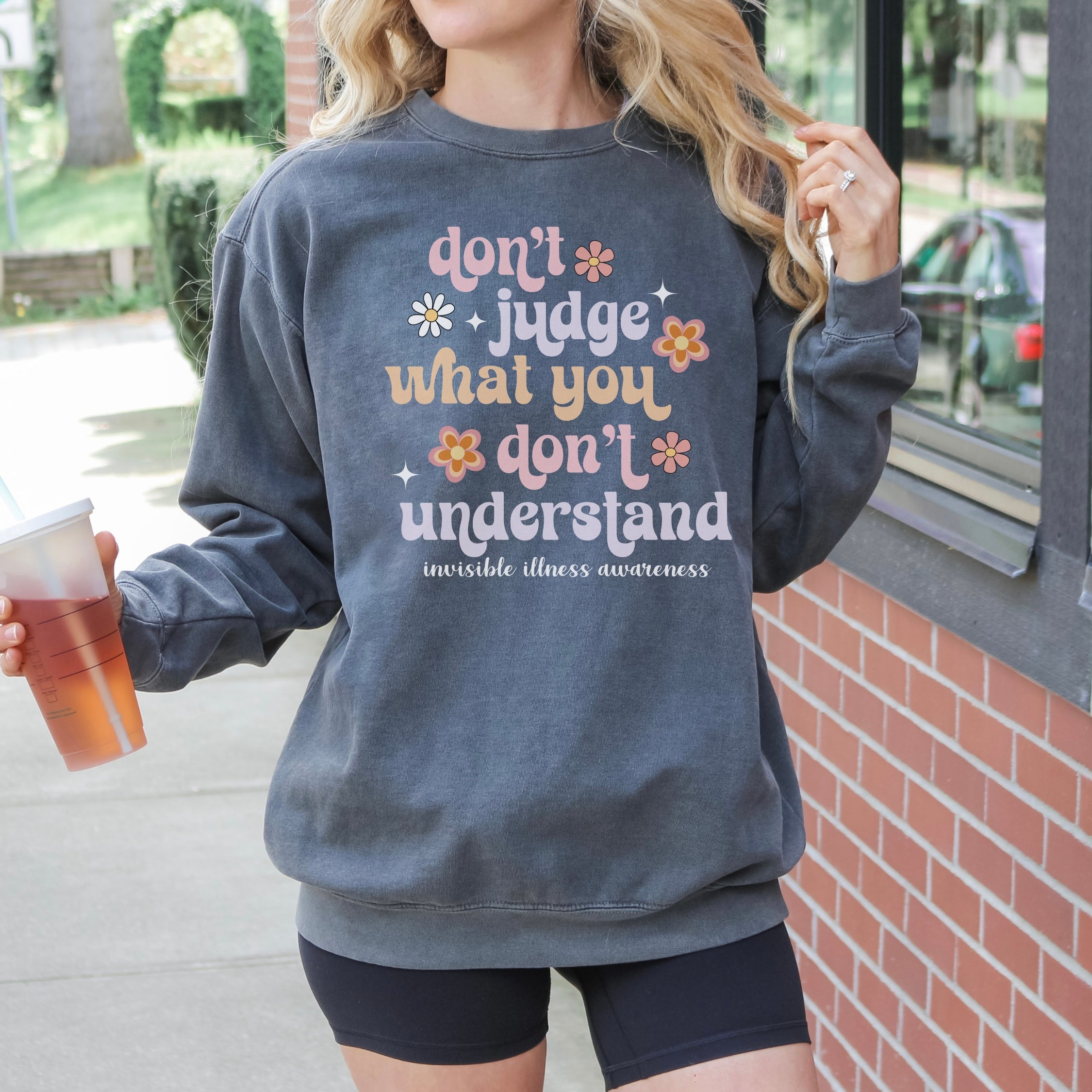 Girl wearing invisible illness Comfort Colors sweatshirt in pepper