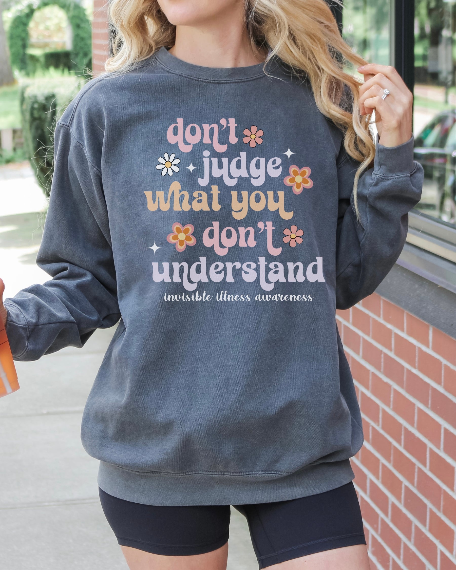 Girl wearing invisible illness Comfort Colors sweatshirt in pepper
