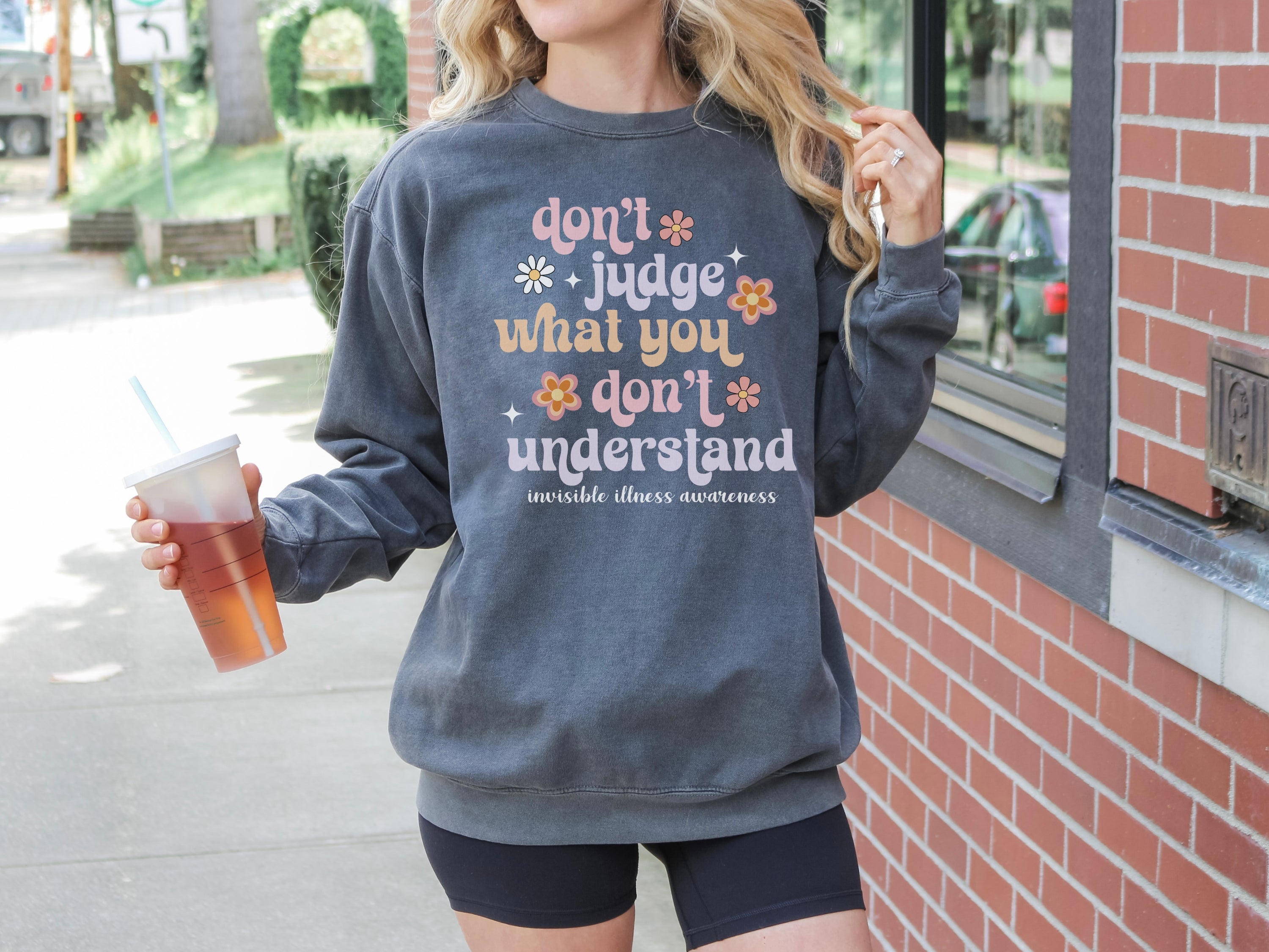 Girl wearing invisible illness Comfort Colors sweatshirt in pepper