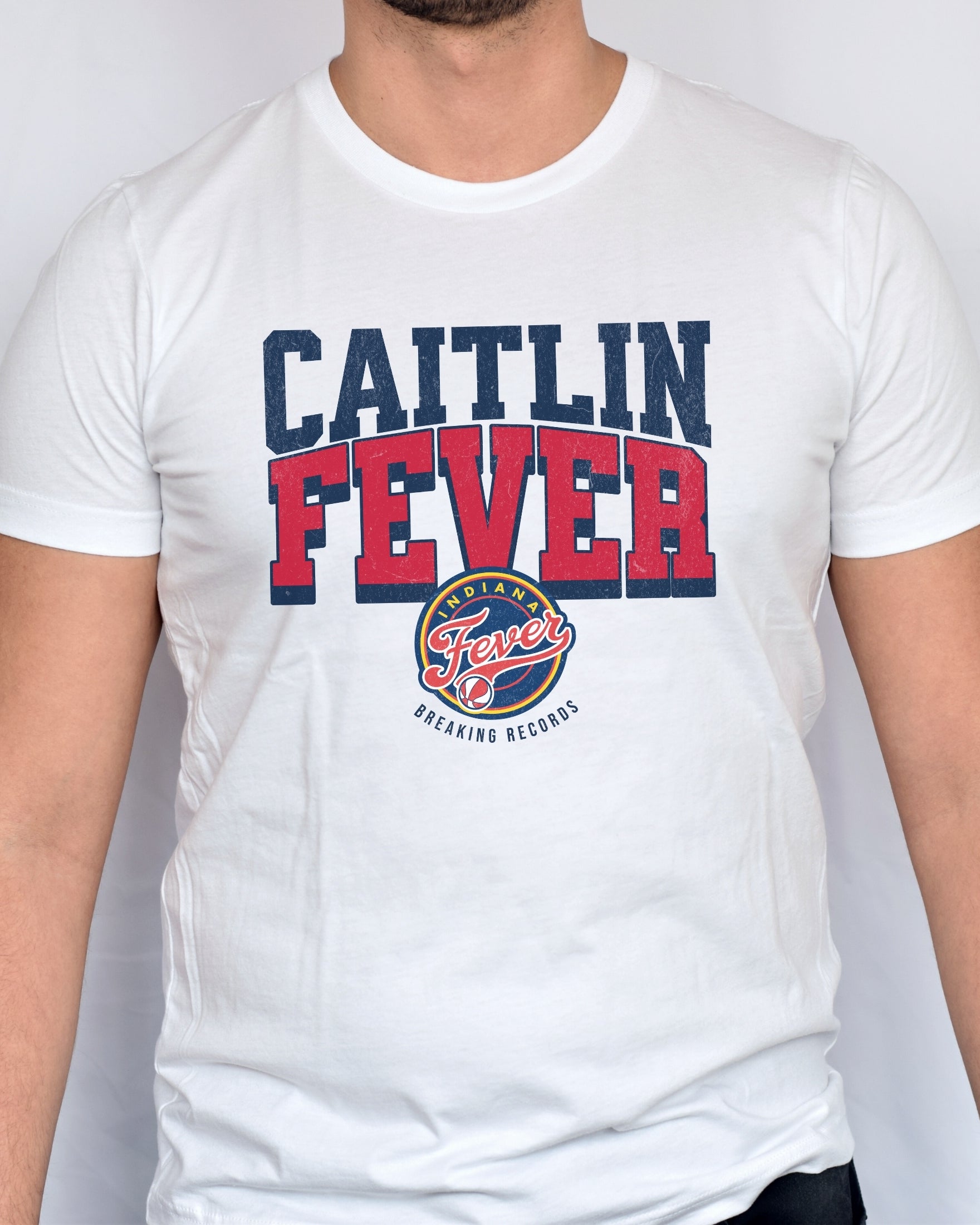 Man wearing white Caitlin Fever Record Breaking shirt