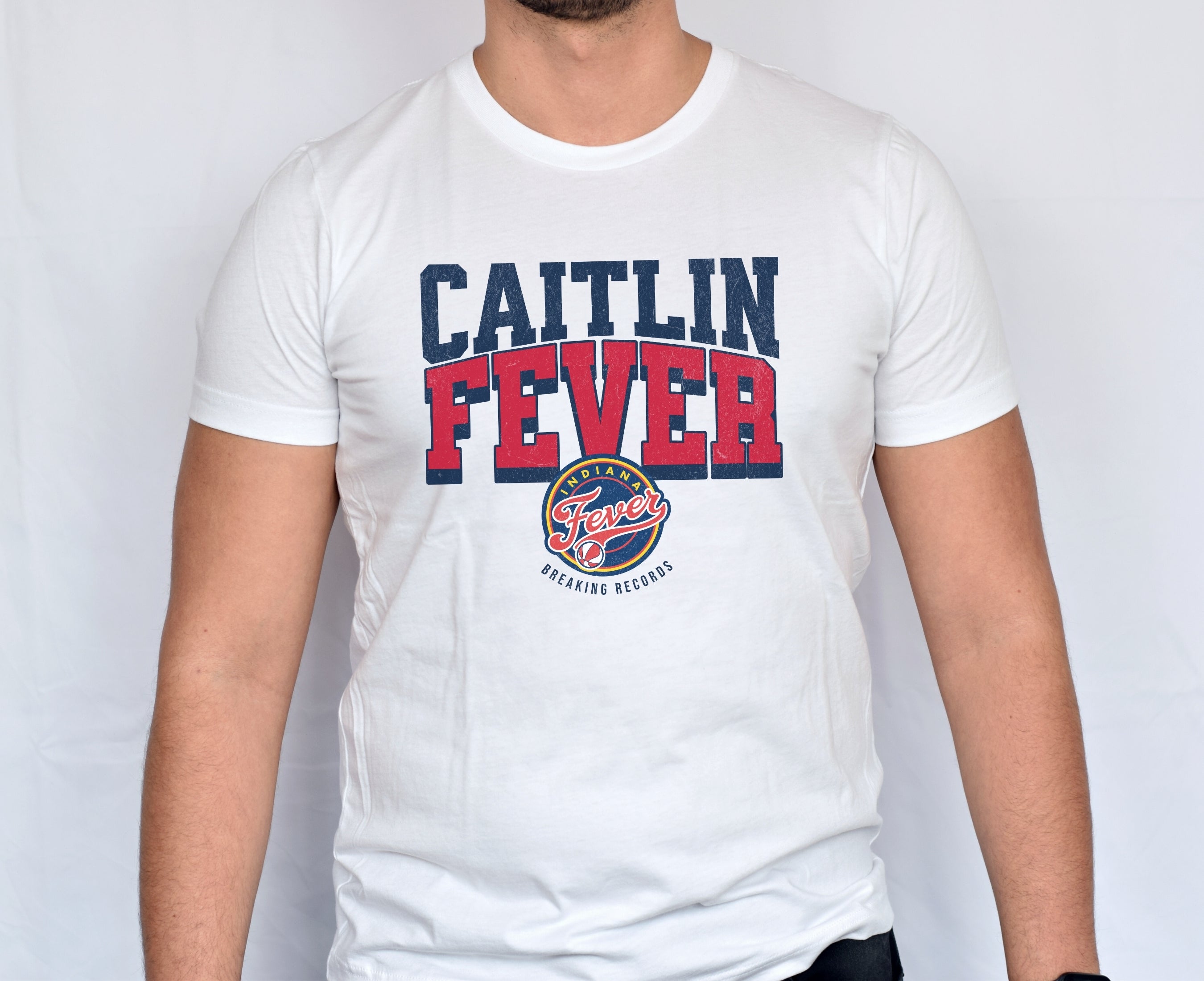 Man wearing white Caitlin Fever Record Breaking shirt