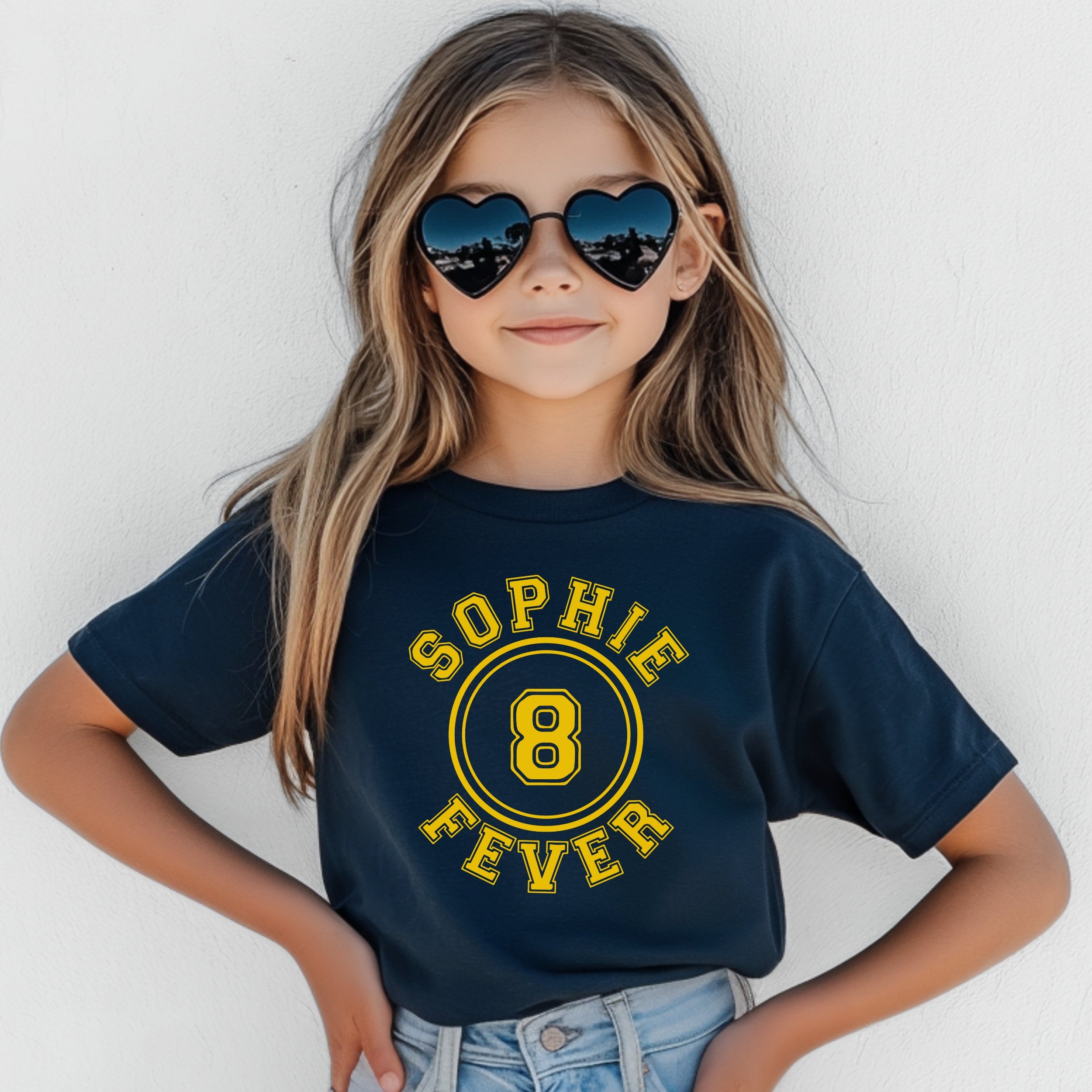 Child wearing a navy blue t-shirt with 'Sophie Fever' and number '8' design, against a white background.