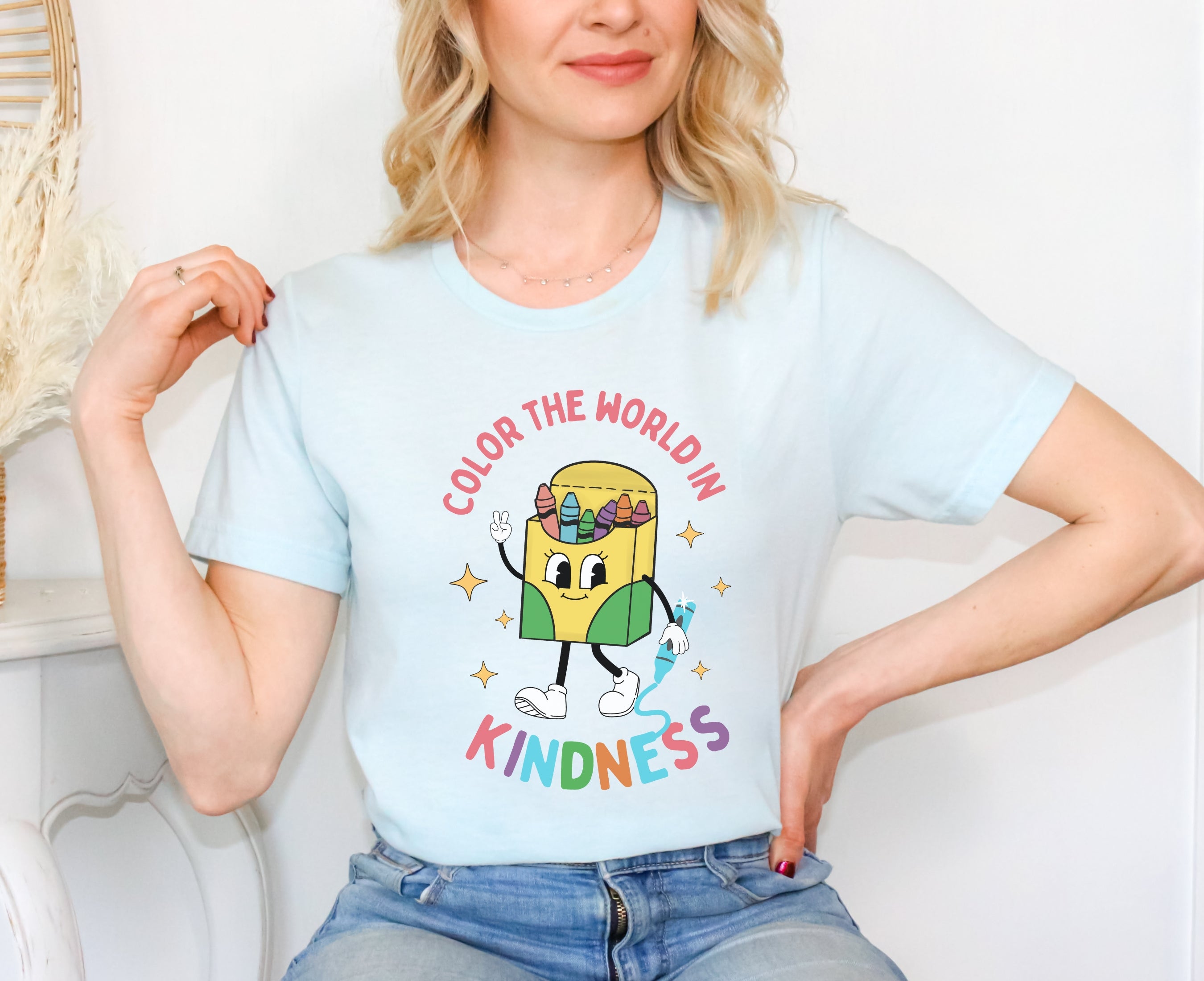 Woman wearing heather ice blue - color the world in kindness shirt