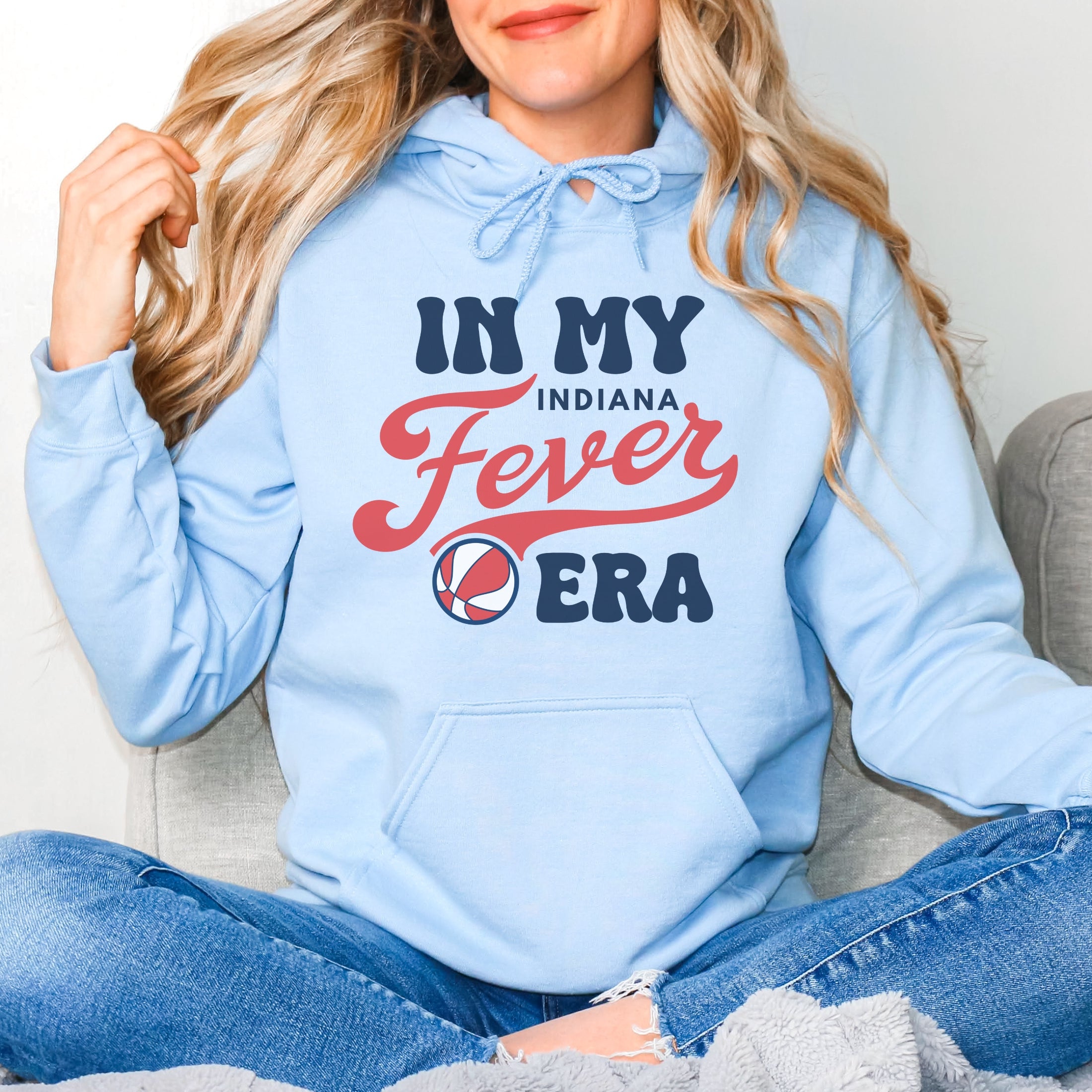 Girl wearing light blue in my Fever era hoodie