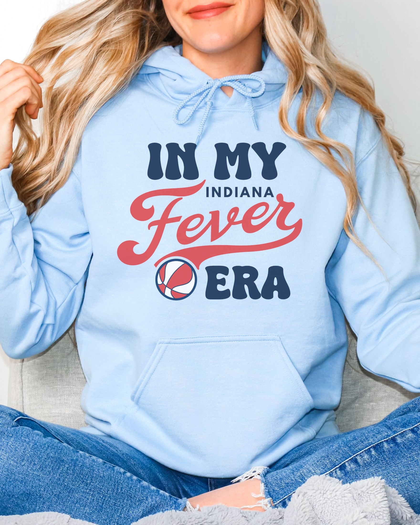Girl wearing light blue in my Fever era hoodie