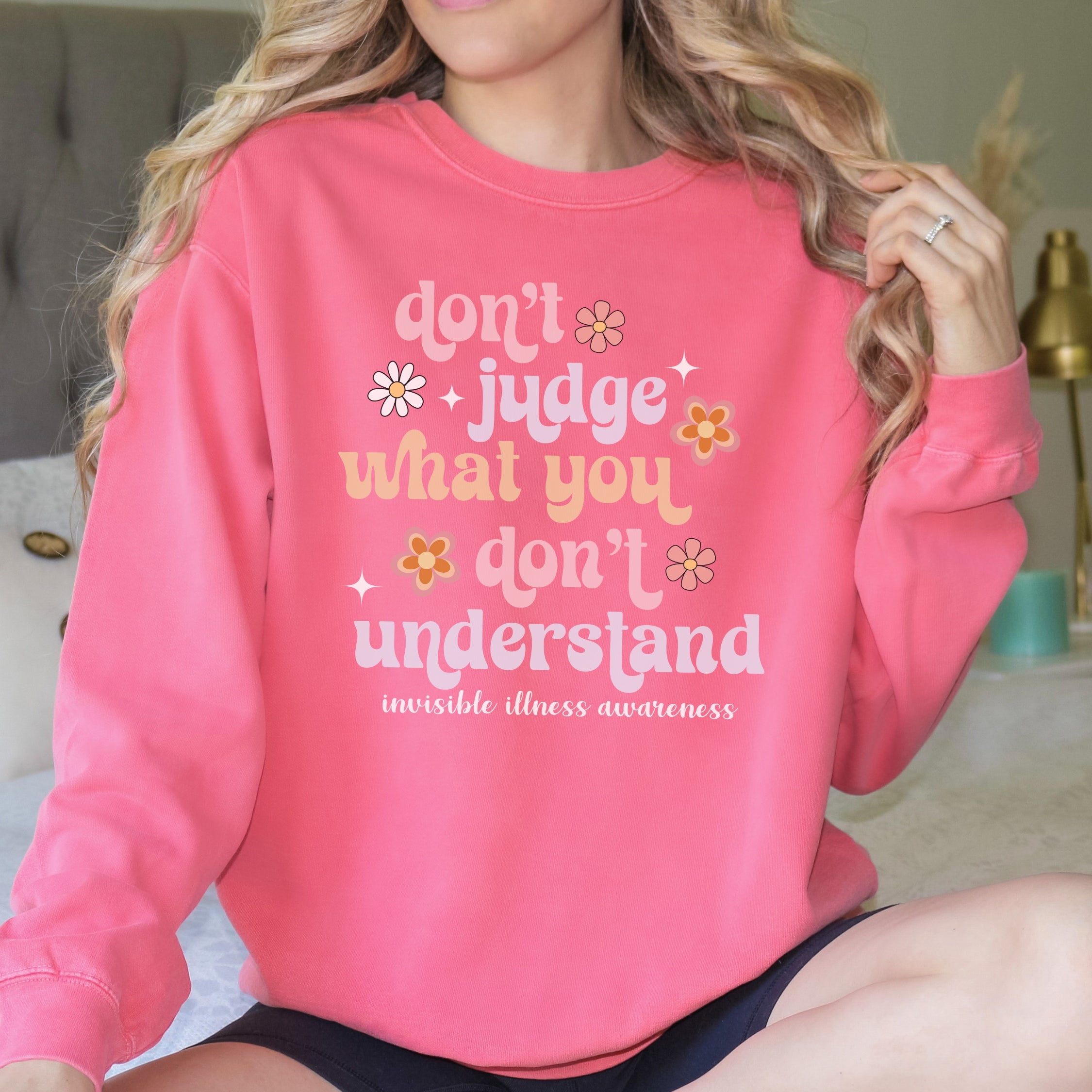 Girl wearing invisible illness Comfort Colors sweatshirt in watermelon