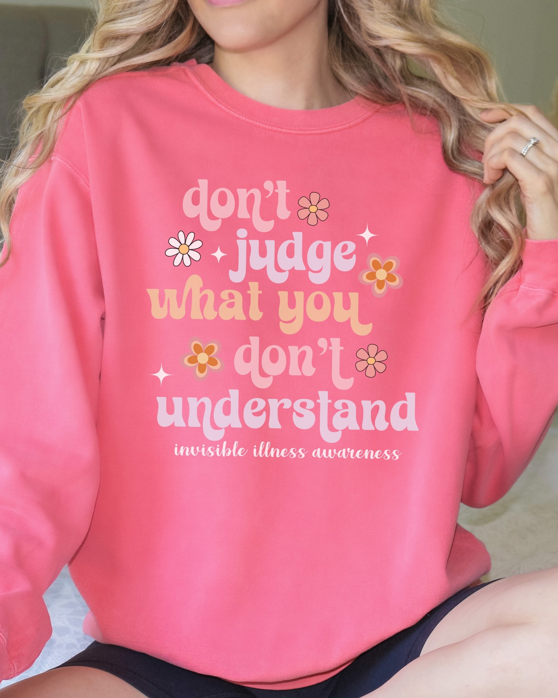 Girl wearing invisible illness Comfort Colors sweatshirt in watermelon
