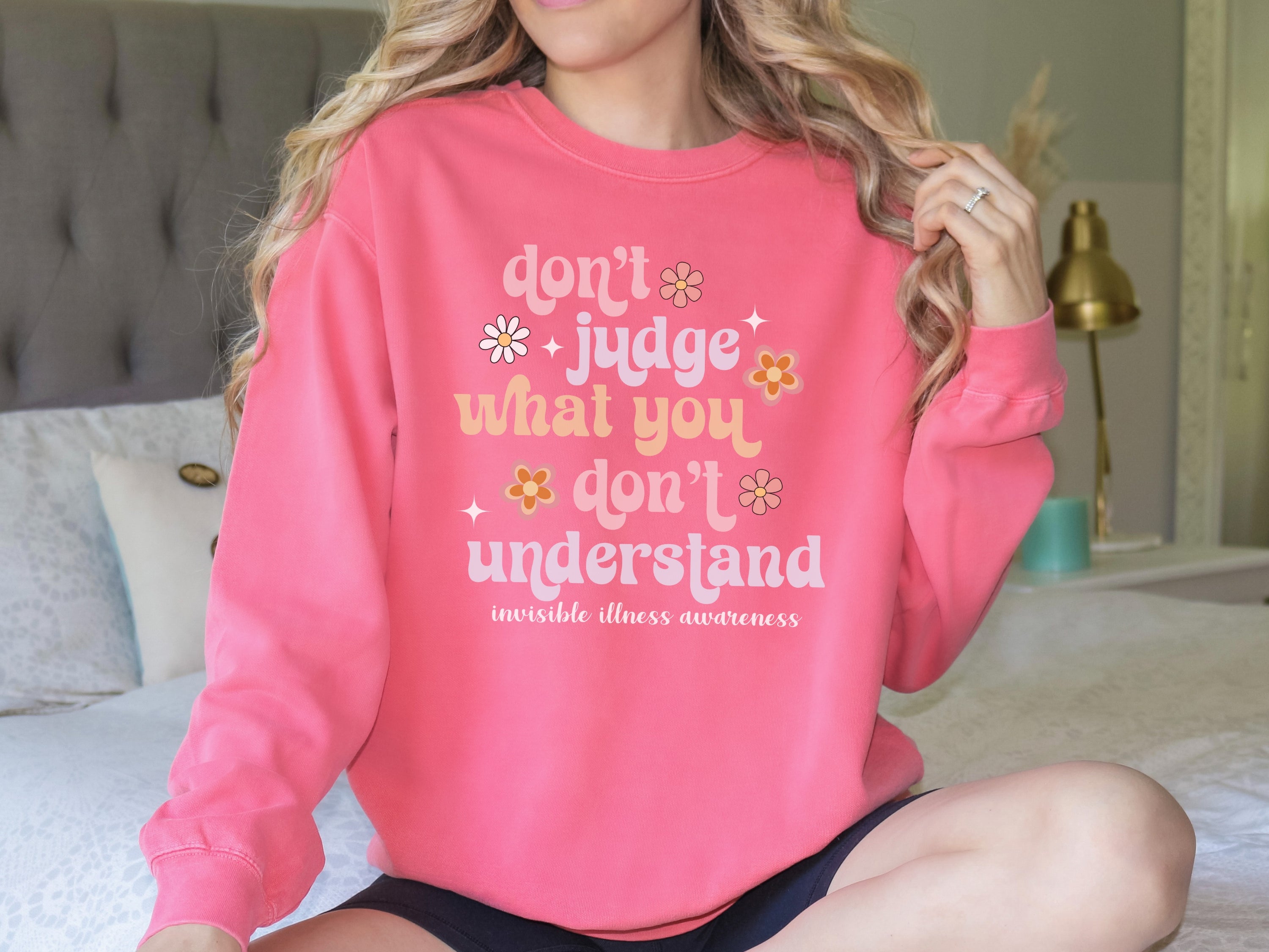 Girl wearing invisible illness Comfort Colors sweatshirt in watermelon