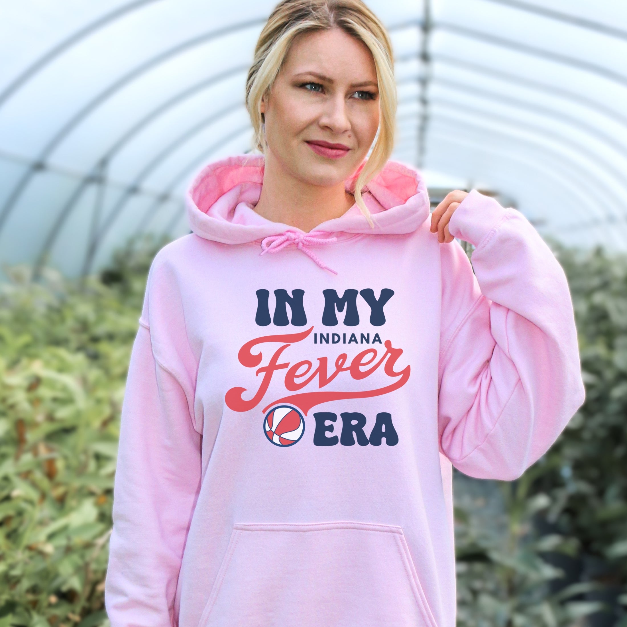 Girl wearing light pink in my Fever era hoodie