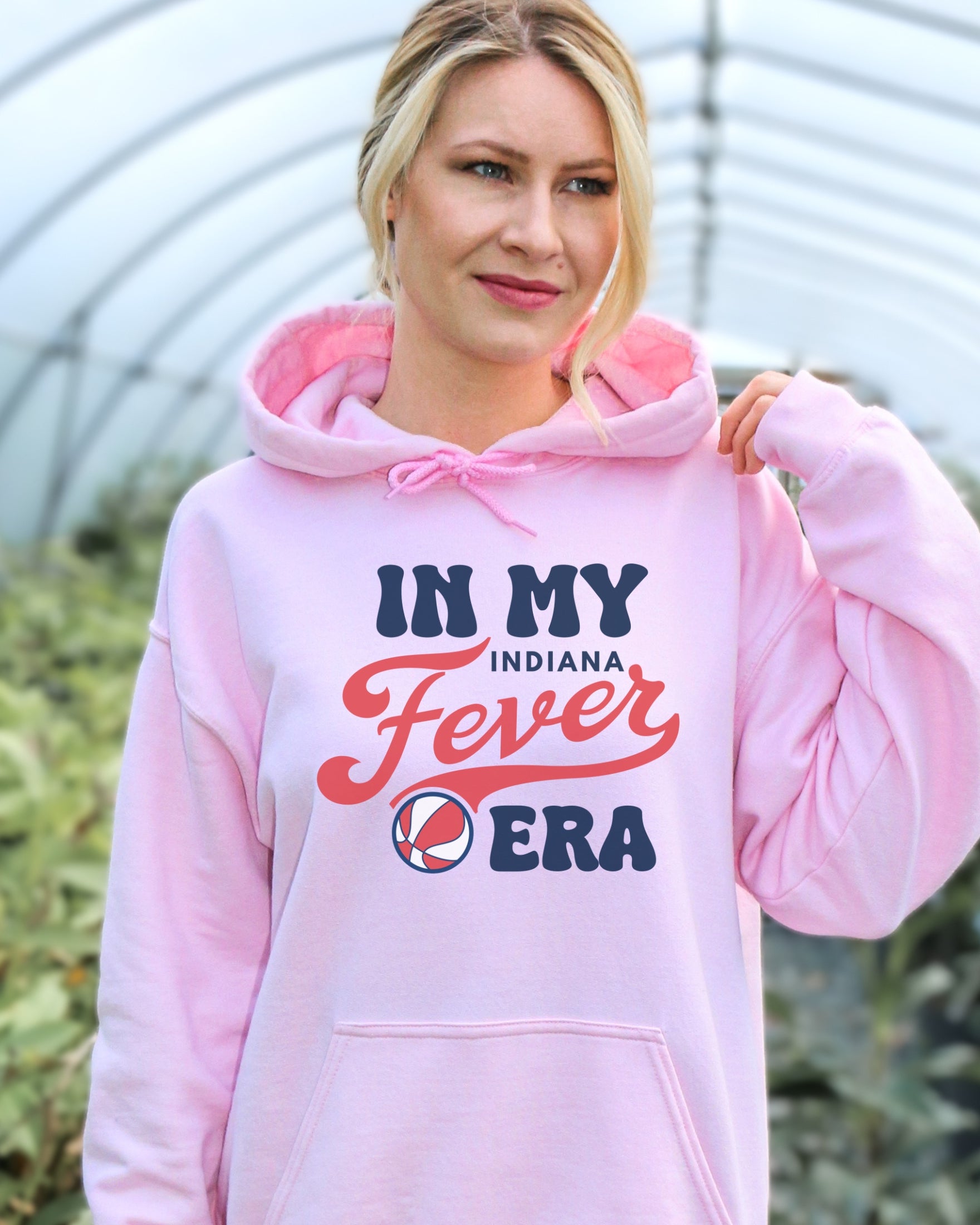 Girl wearing light pink in my Fever era hoodie