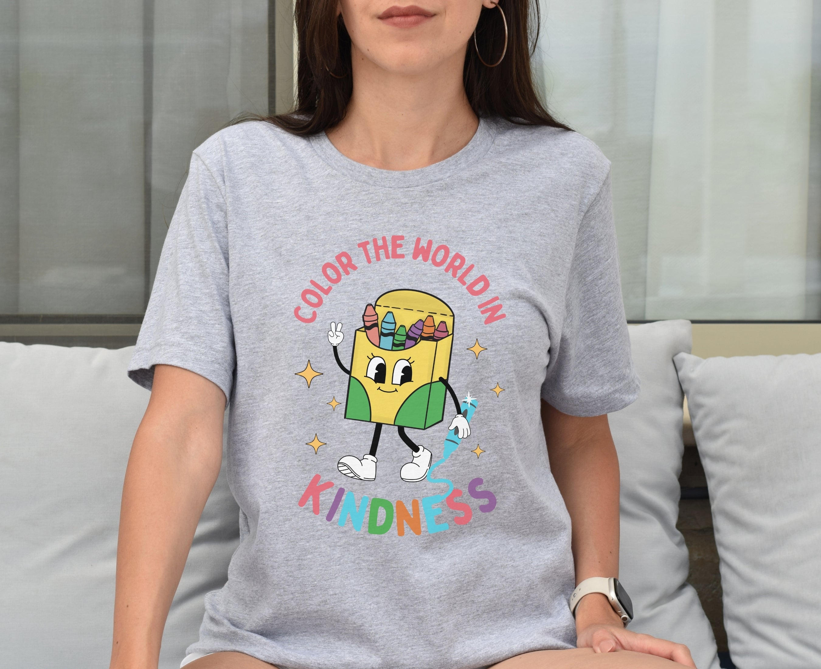 Teacher wearing athletic heather be kind retro shirt