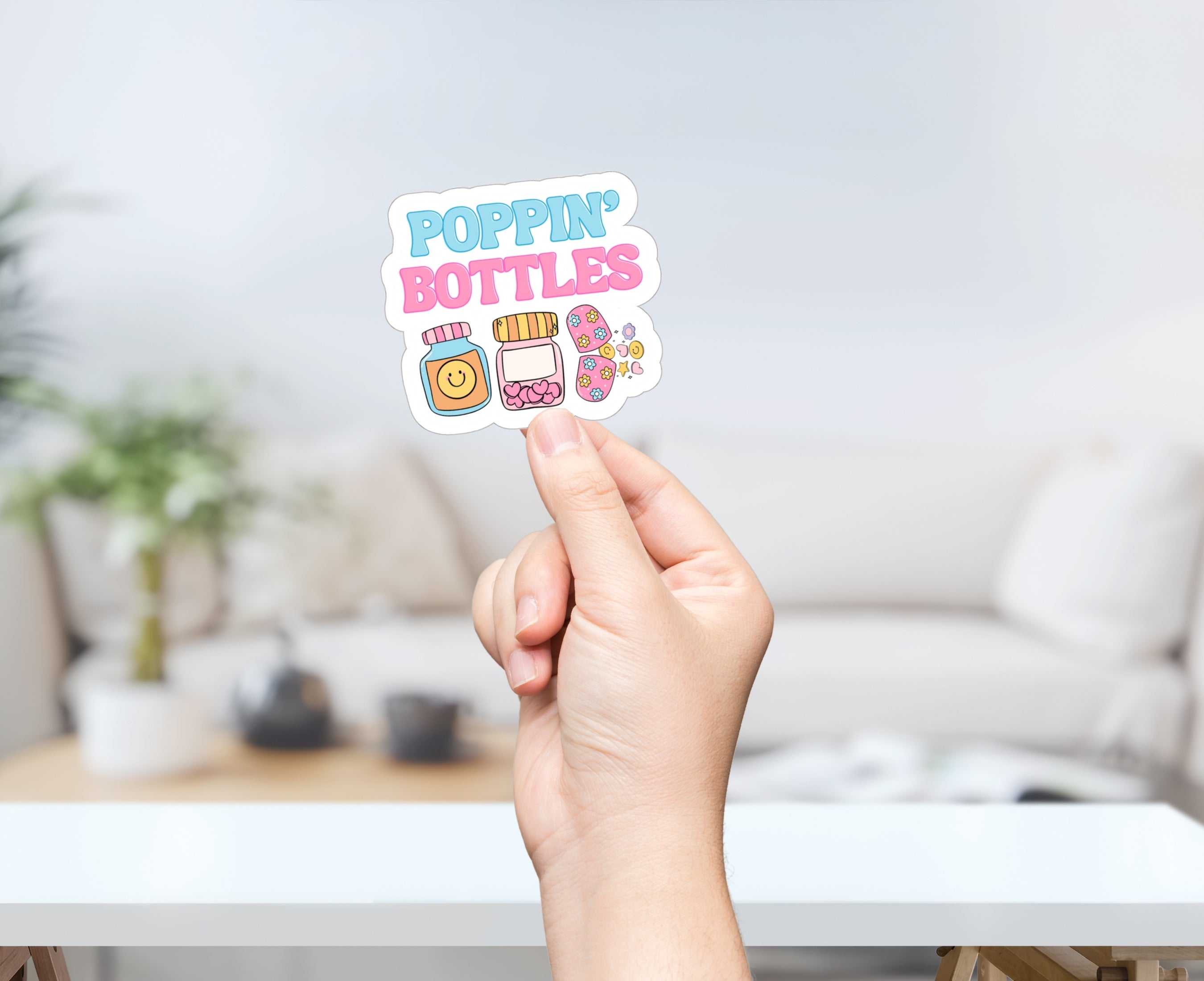 Person holding Poppin' Bottles sticker