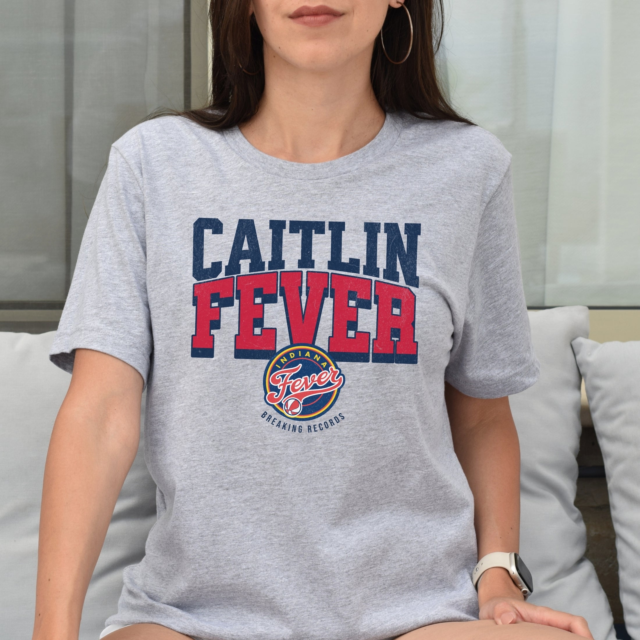 Woman wearing Athletic Heather Caitlin Fever shirt