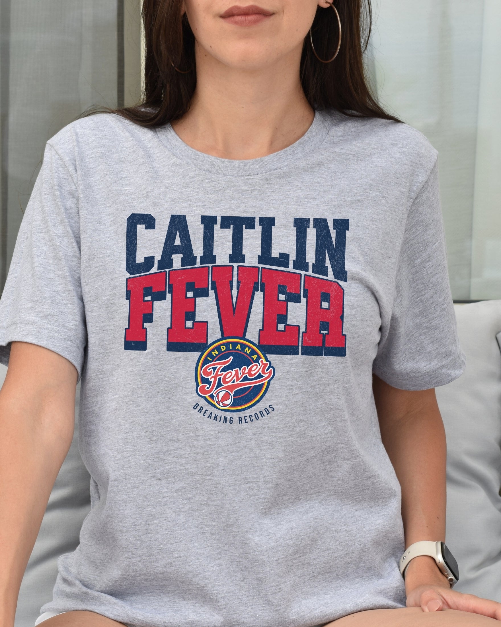 Woman wearing Athletic Heather Caitlin Fever shirt