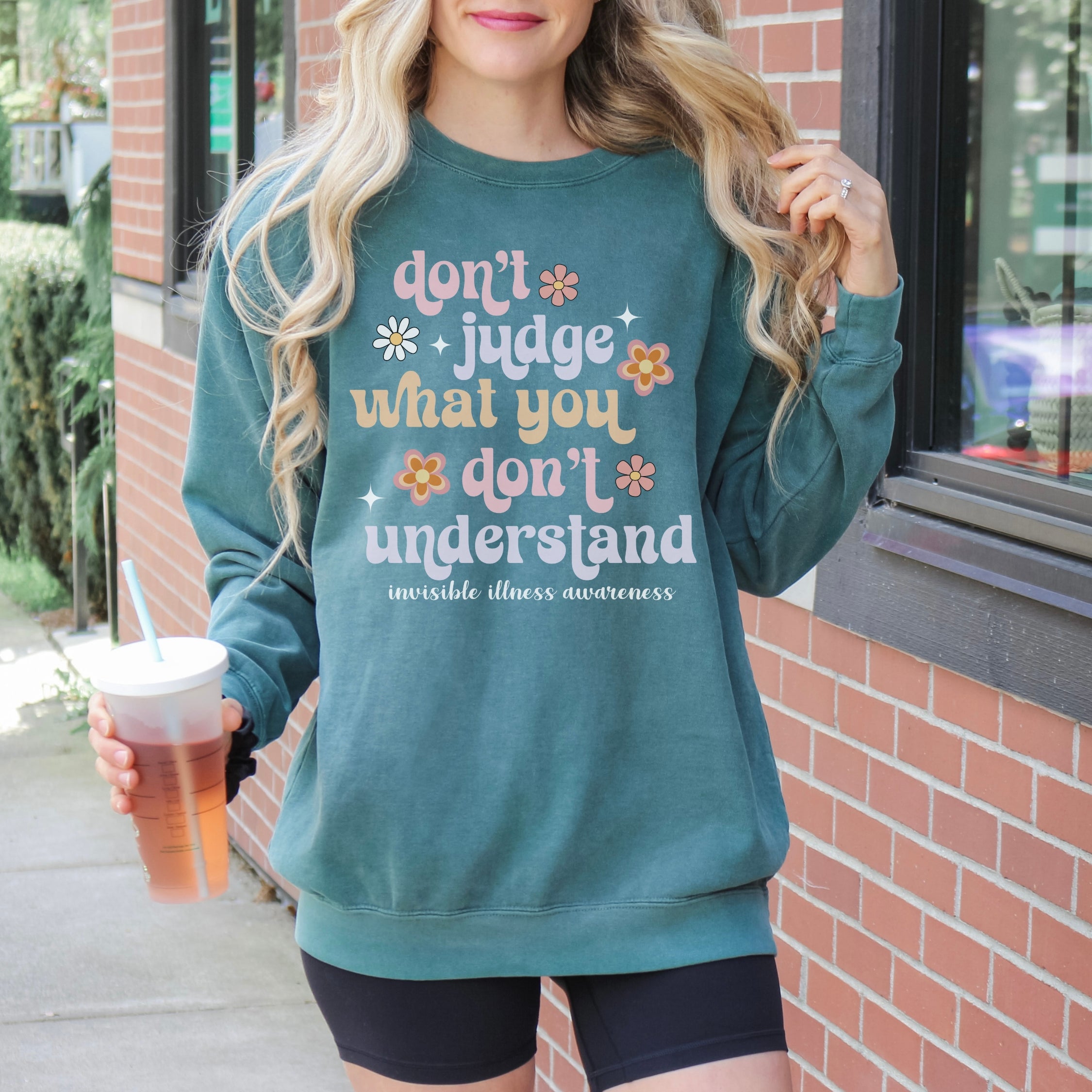 Girl wearing invisible illness Comfort Colors sweatshirt in blue spruce