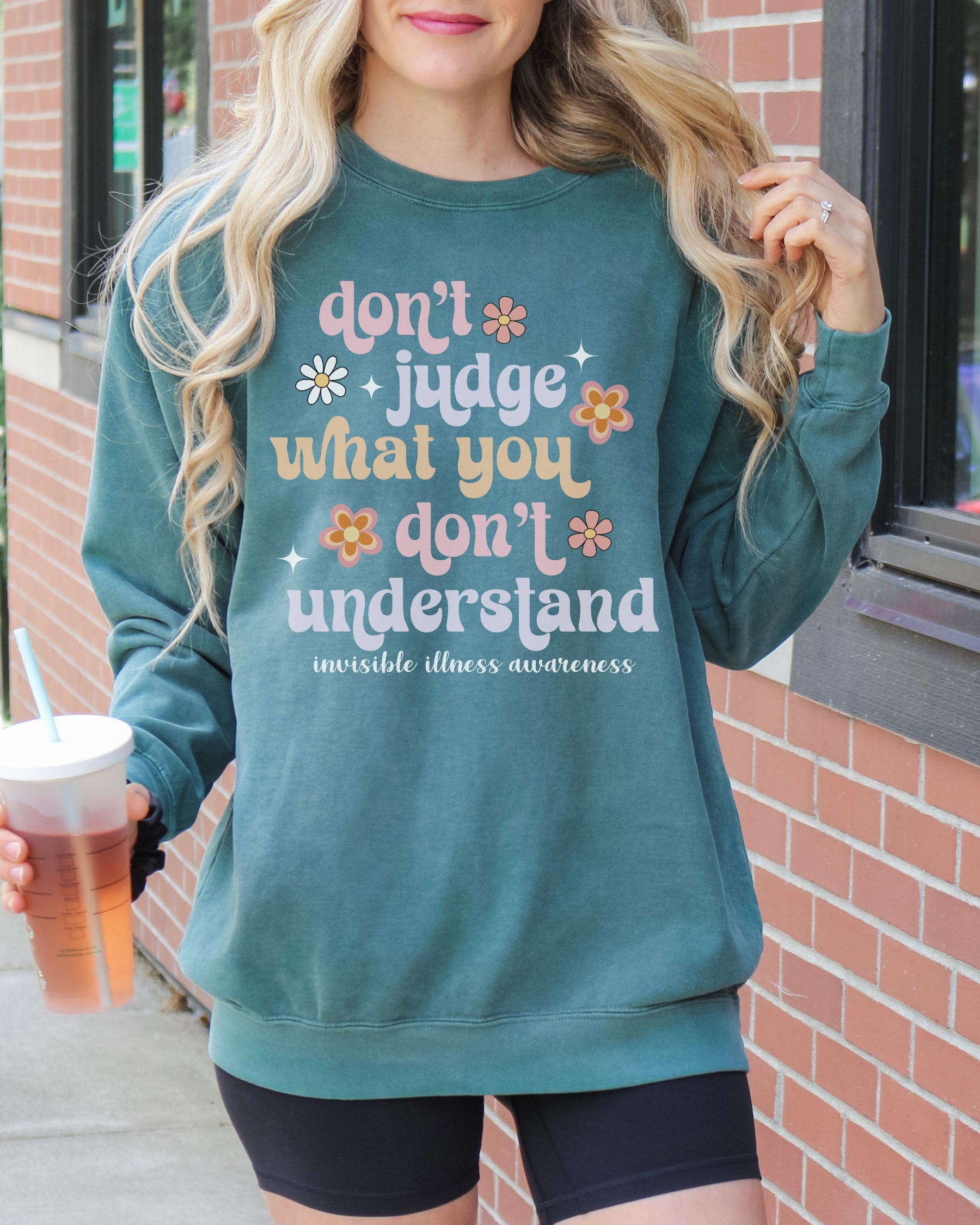 Girl wearing invisible illness Comfort Colors sweatshirt in blue spruce