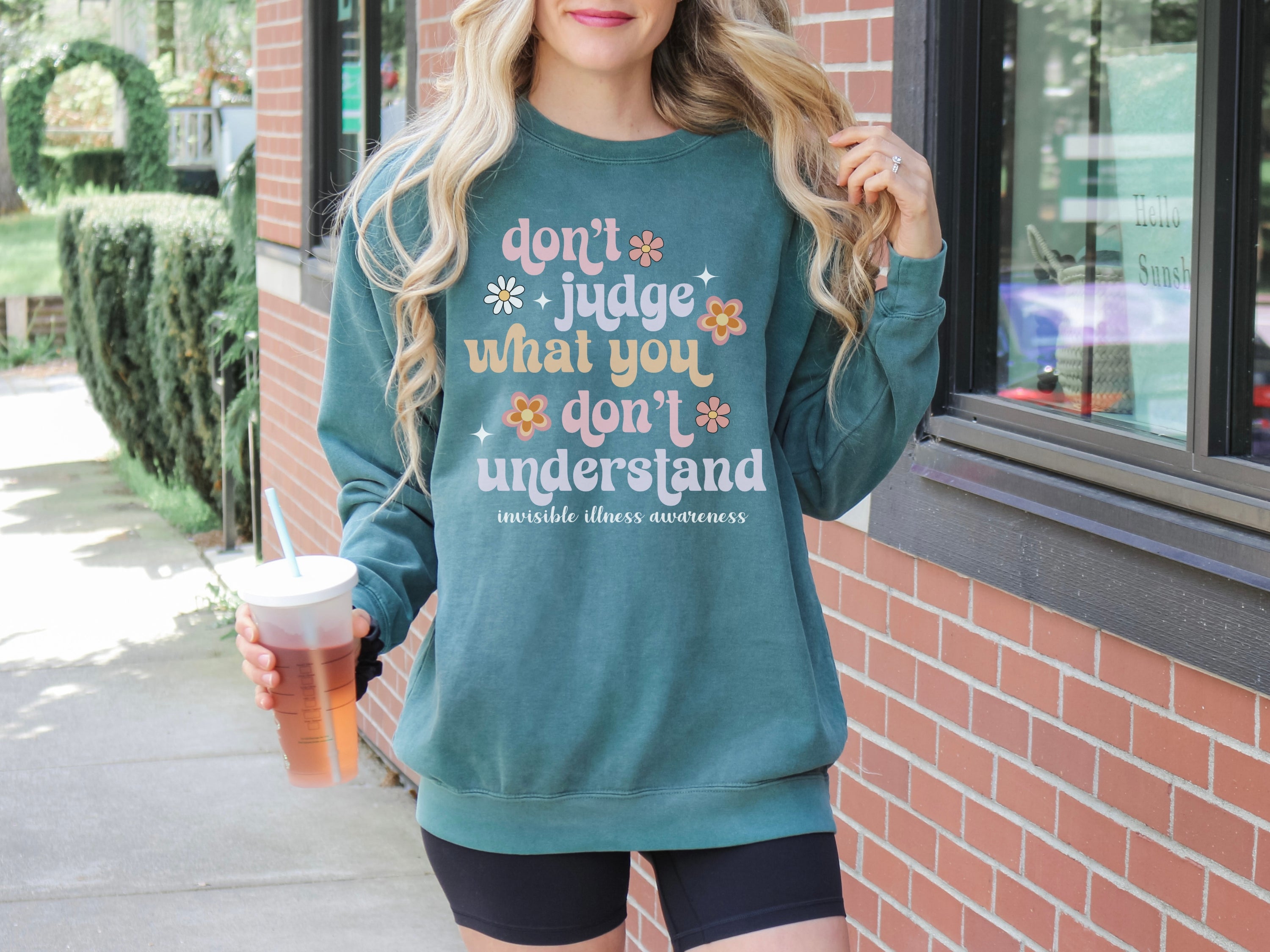 Girl wearing invisible illness Comfort Colors sweatshirt in blue spruce