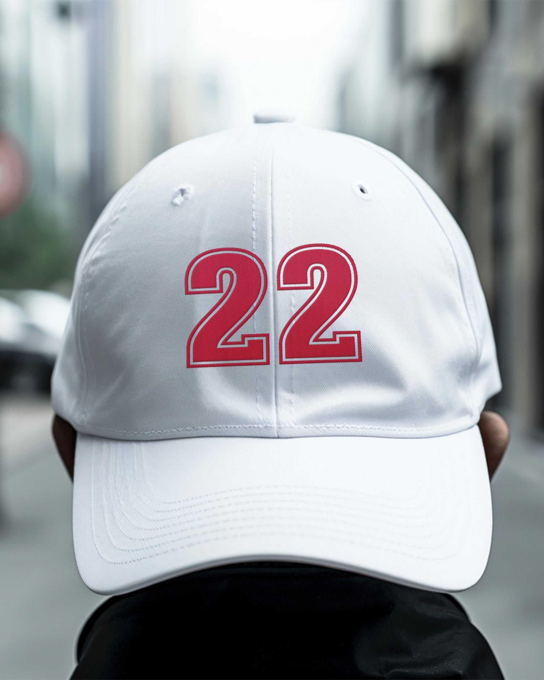 Man wearing white number 22 dad hat backwards