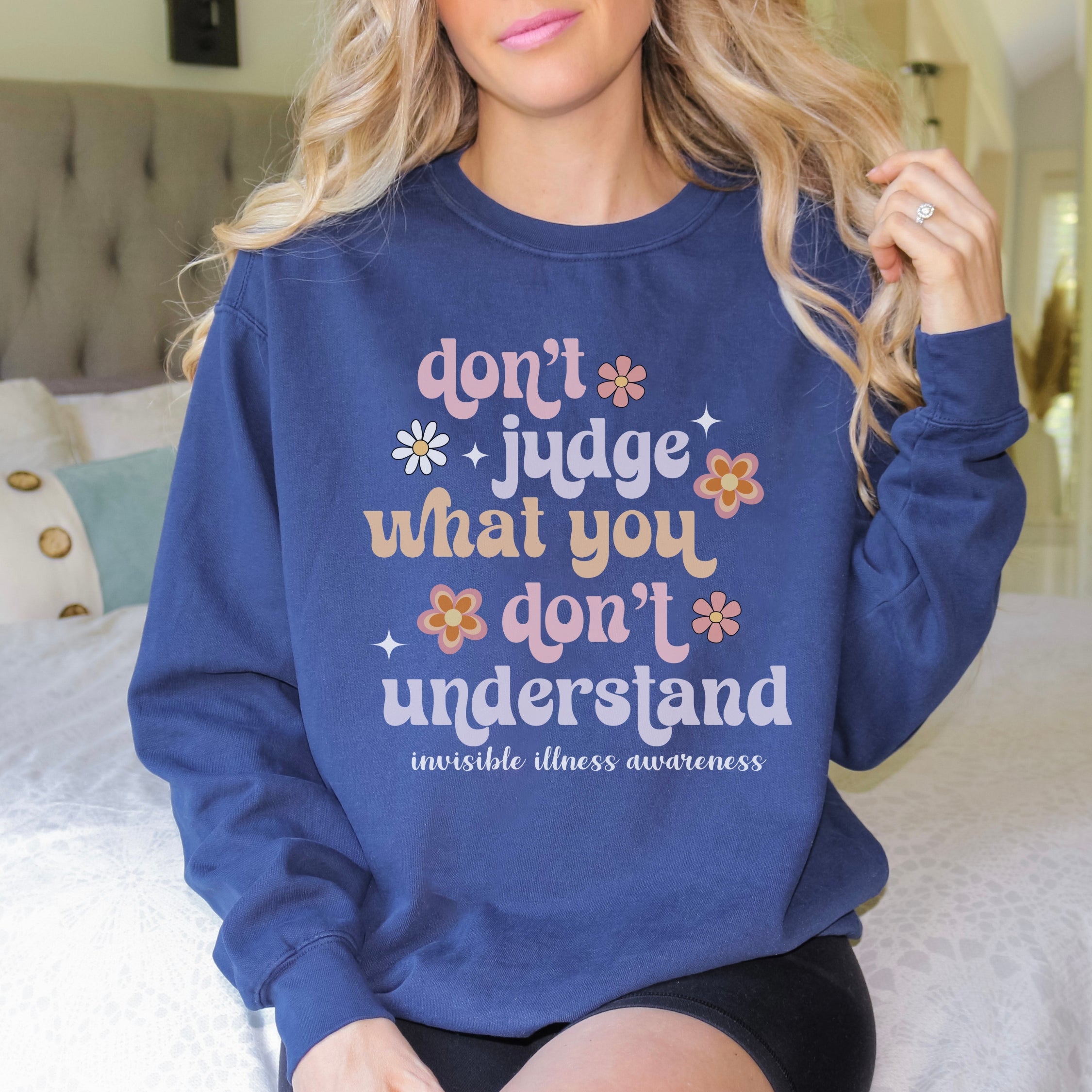 Girl wearing invisible illness Comfort Colors sweatshirt in true navy