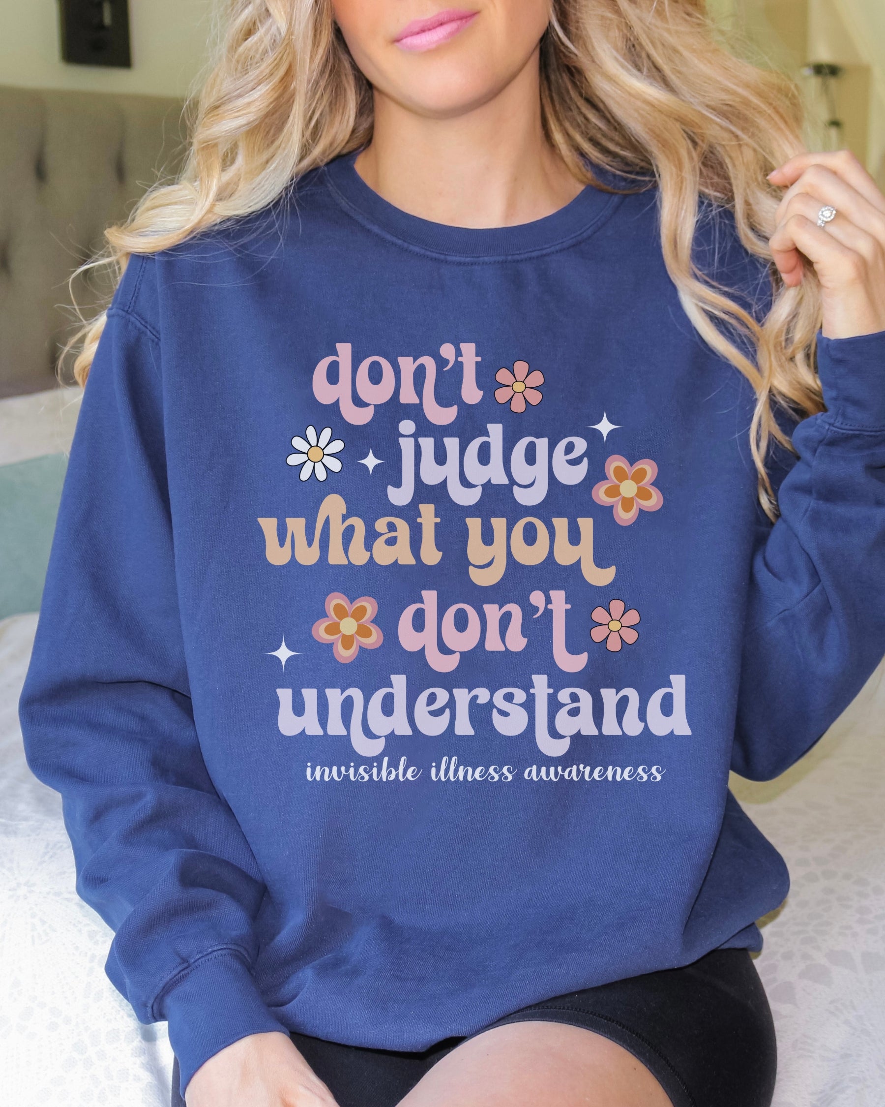 Girl wearing invisible illness Comfort Colors sweatshirt in true navy