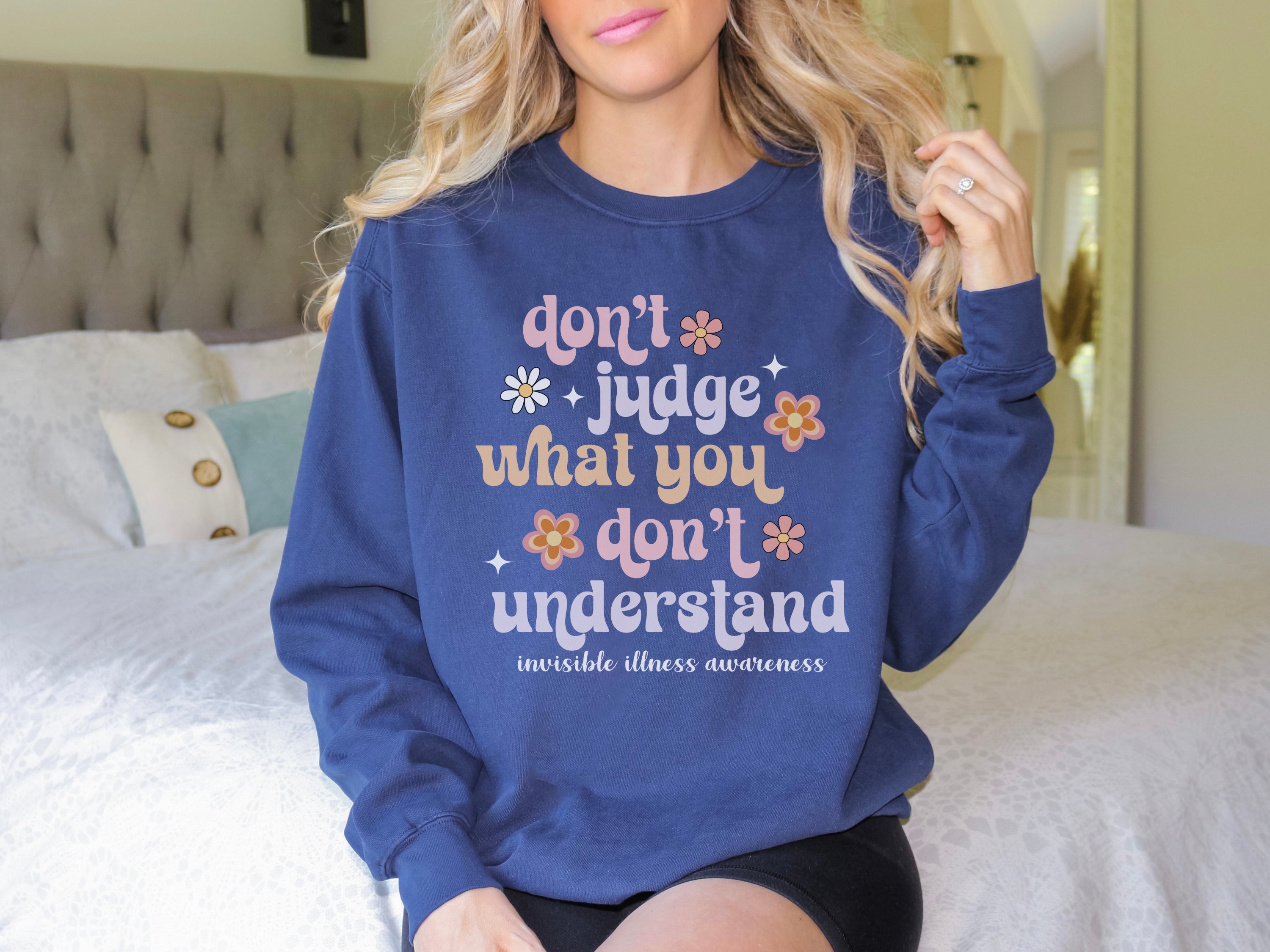 Girl wearing invisible illness Comfort Colors sweatshirt in true navy