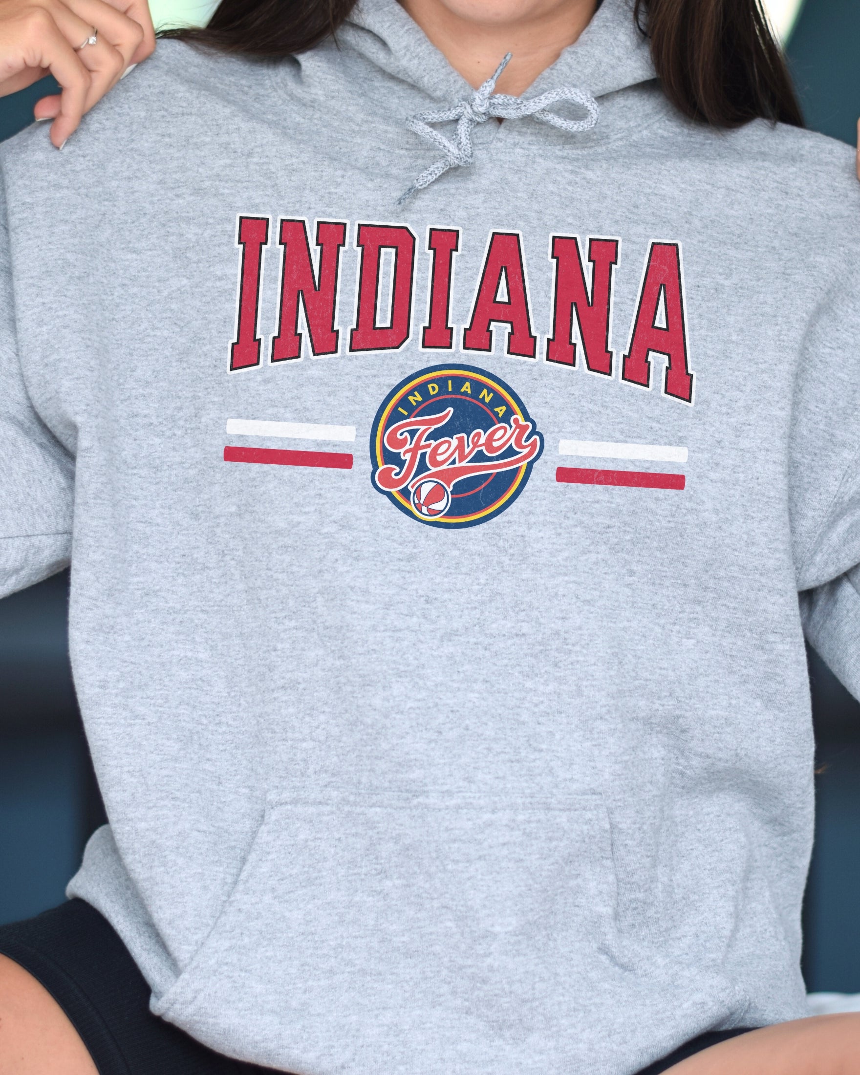 Woman wearing athletic heather Indiana Fever Hoodie Sweatshirt