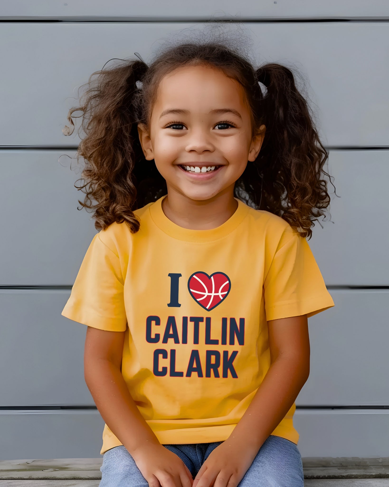 Little girl wearing I love Caitlin Clark heather yellow gold t-shirt