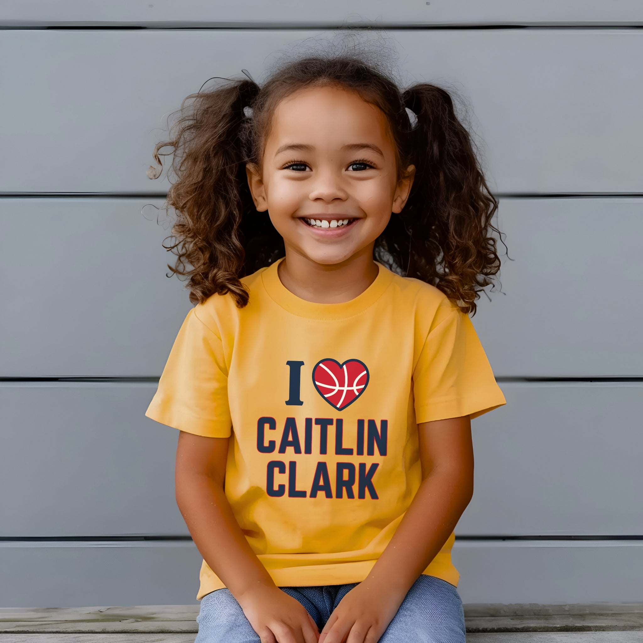 Little girl wearing I love Caitlin Clark heather yellow gold t-shirt