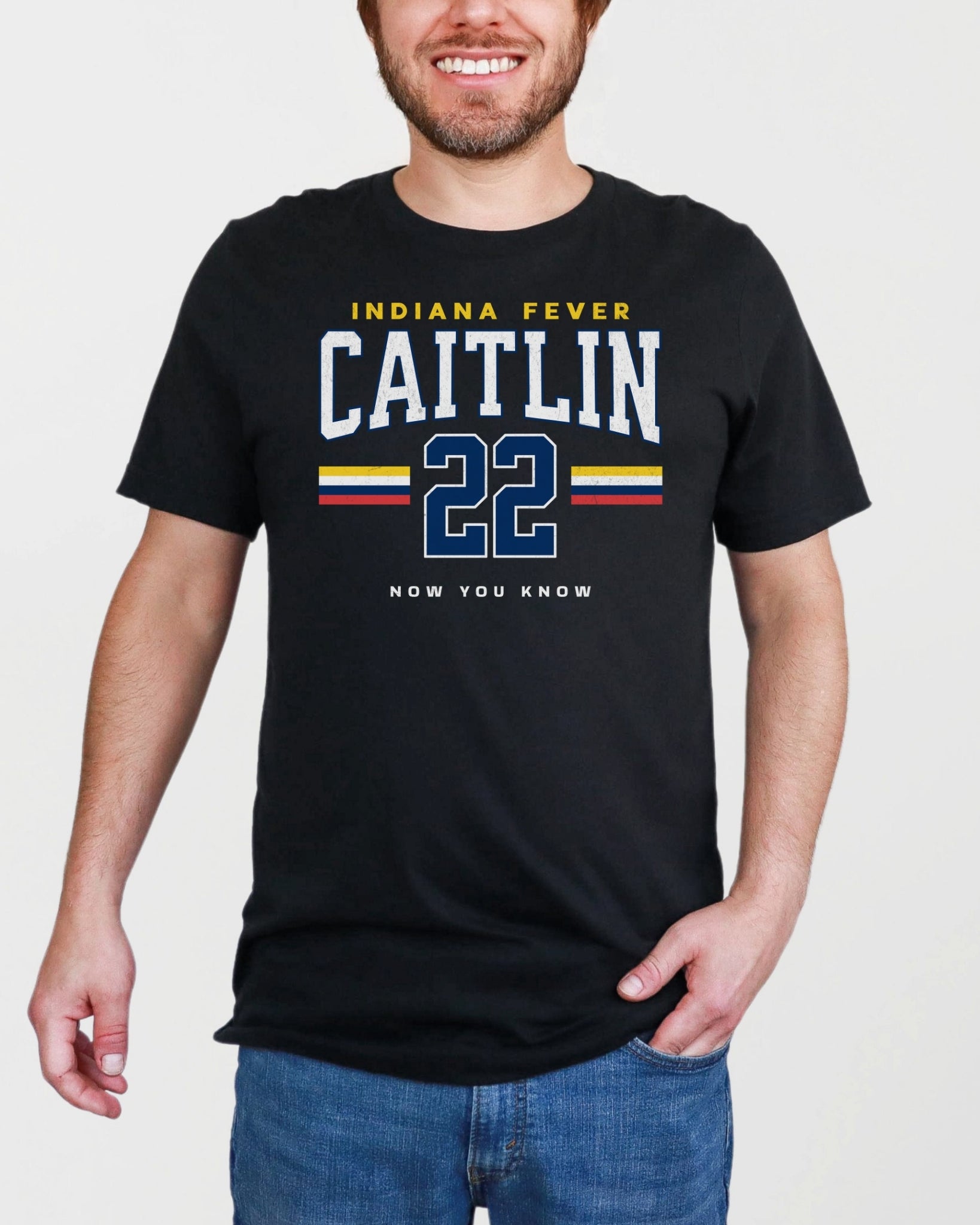 Person wearing a black t-shirt with 'Indiana Fever Caitlin 22' text on a plain background