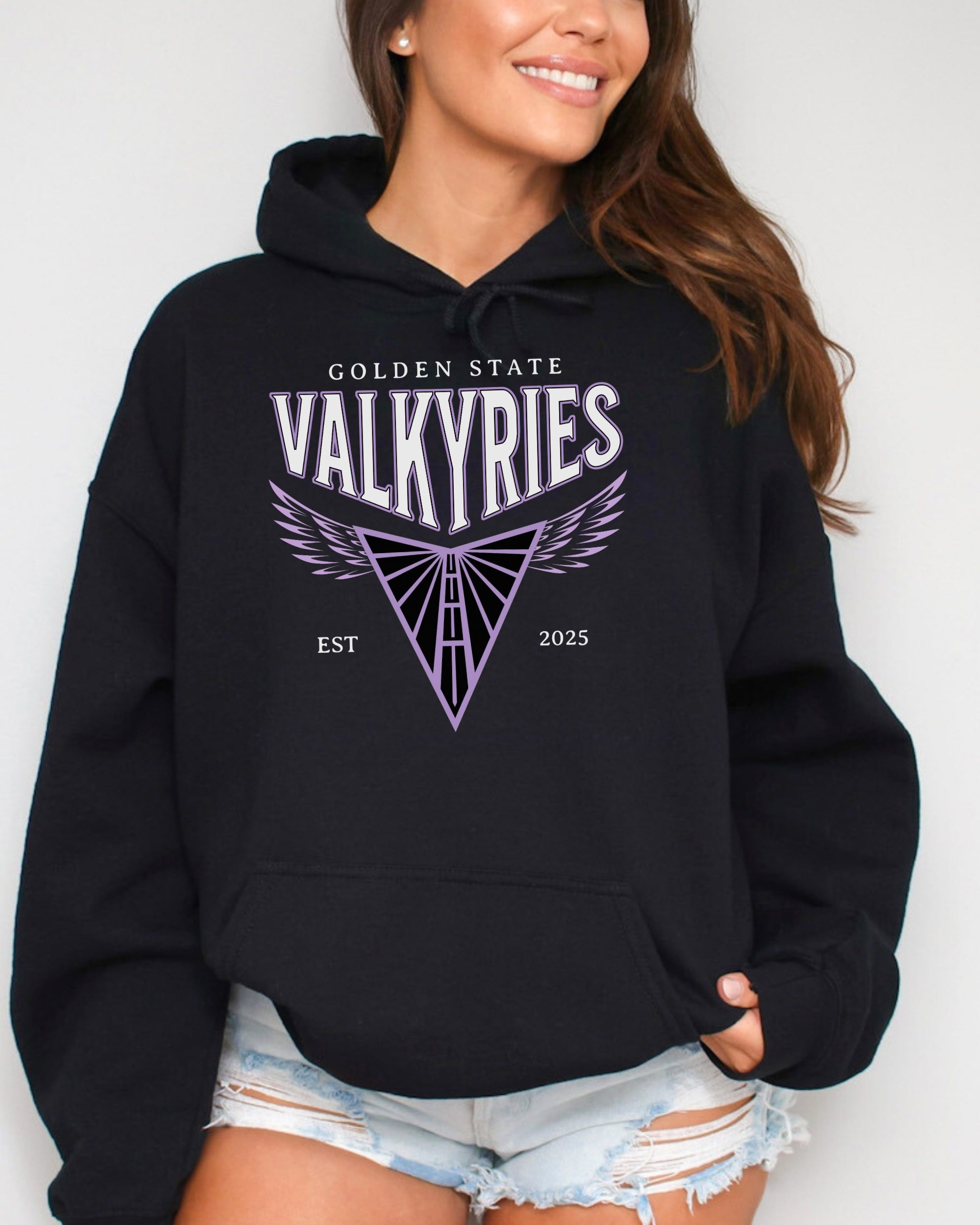 Person wearing a black hoodie with 'Golden State Valkyries' logo on a white background