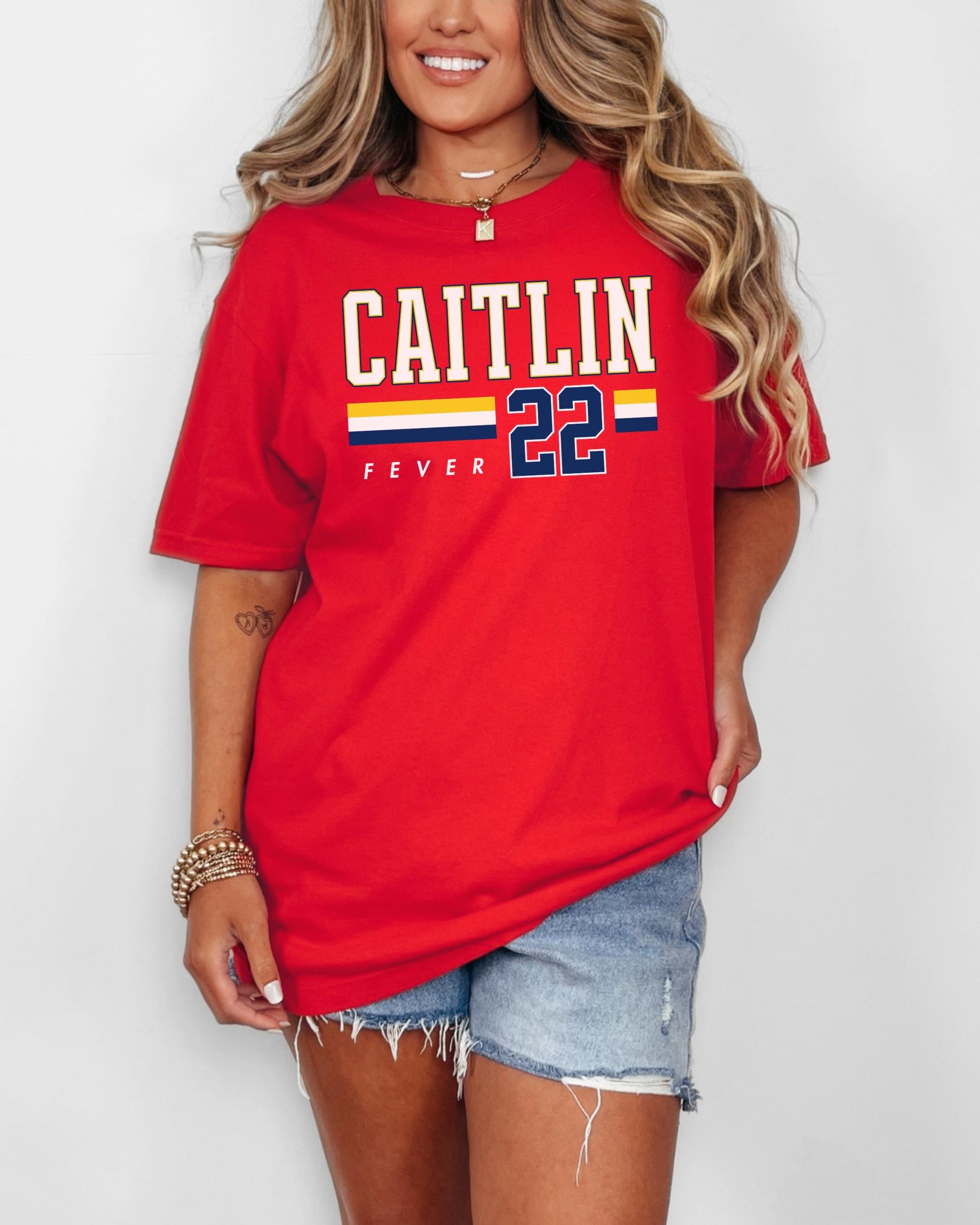Person wearing t-shirt with 'CAITLIN FEVER' printed on it