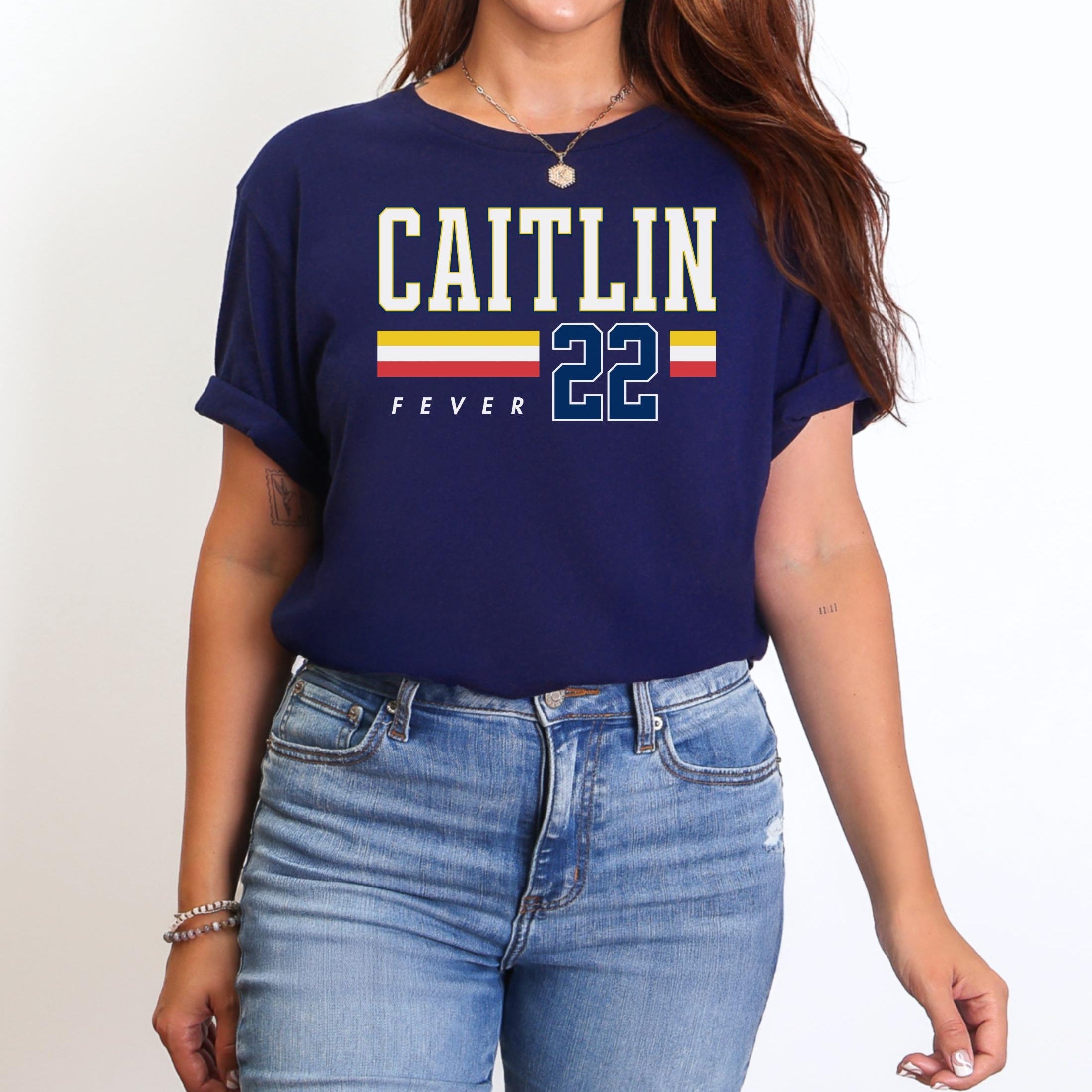 Person wearing t-shirt with 'CAITLIN FEVER' printed on it